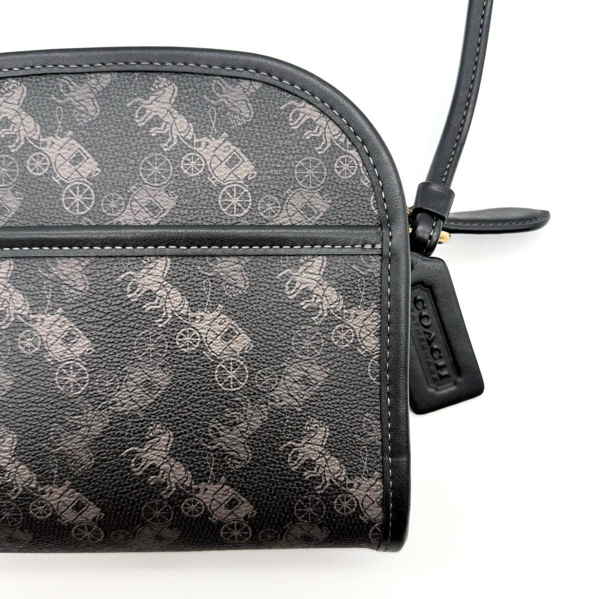 Coach Horse & Carriage Print Zip Crossbody Bag in black coated canvas with adjustable strap and gold hardware.