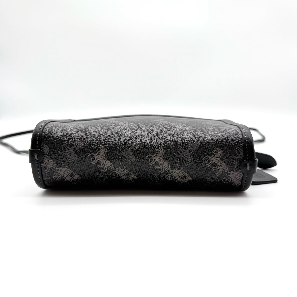Coach Horse & Carriage Print Zip Crossbody Bag in black coated canvas with adjustable strap and gold hardware.