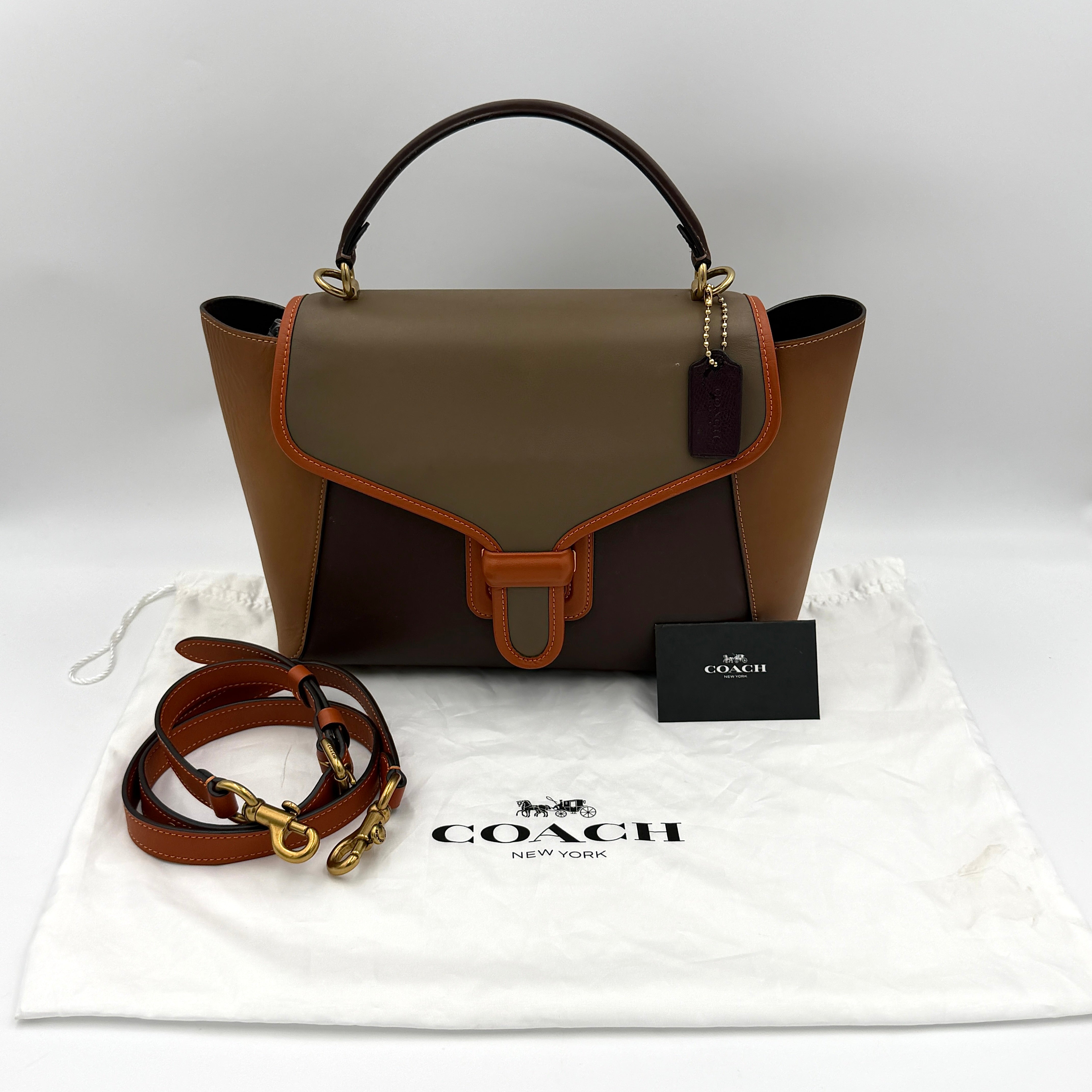 Coach 2Way Courier Carryall in brown and olive green colorblock leather with a structured silhouette, top handle, and detachable strap.