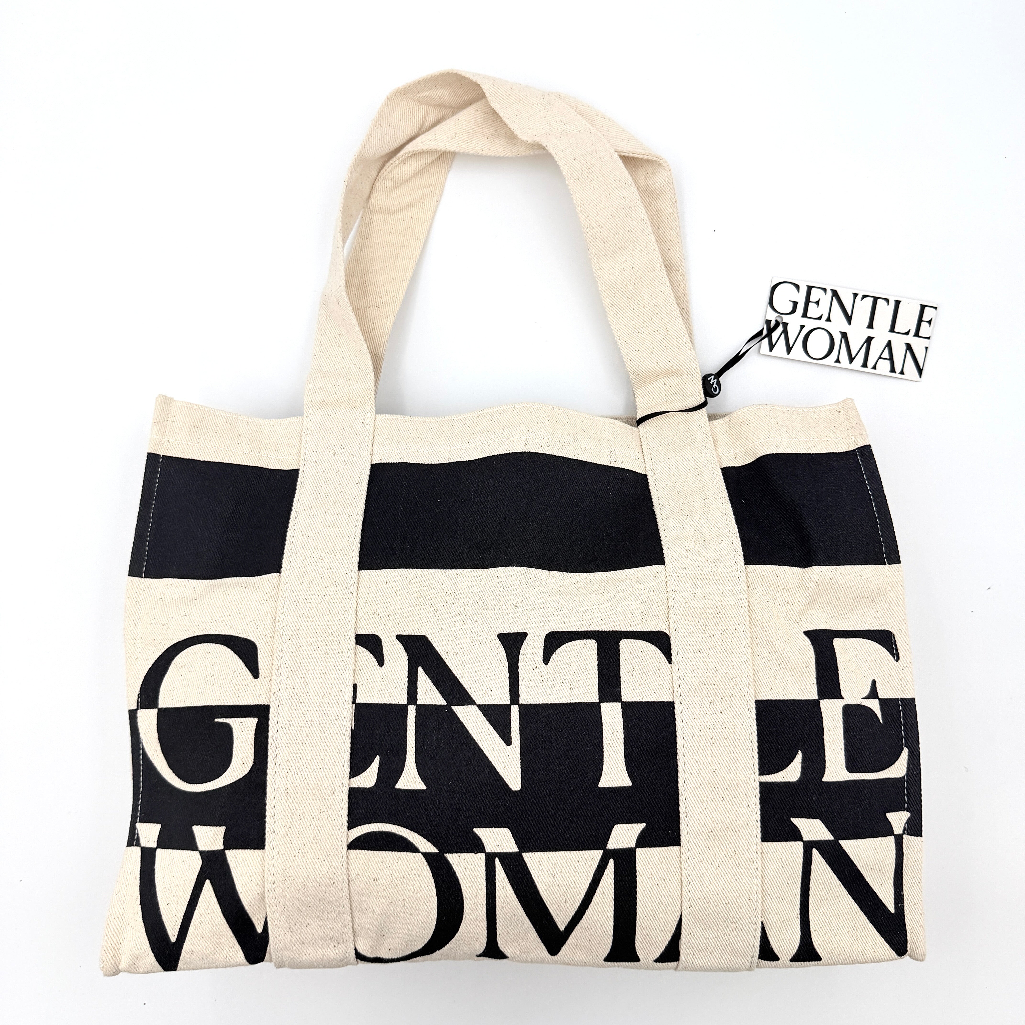 Gentlewoman Canvas Tote Bag in cream and black canvas with bold oversized logo and twin carry handles.