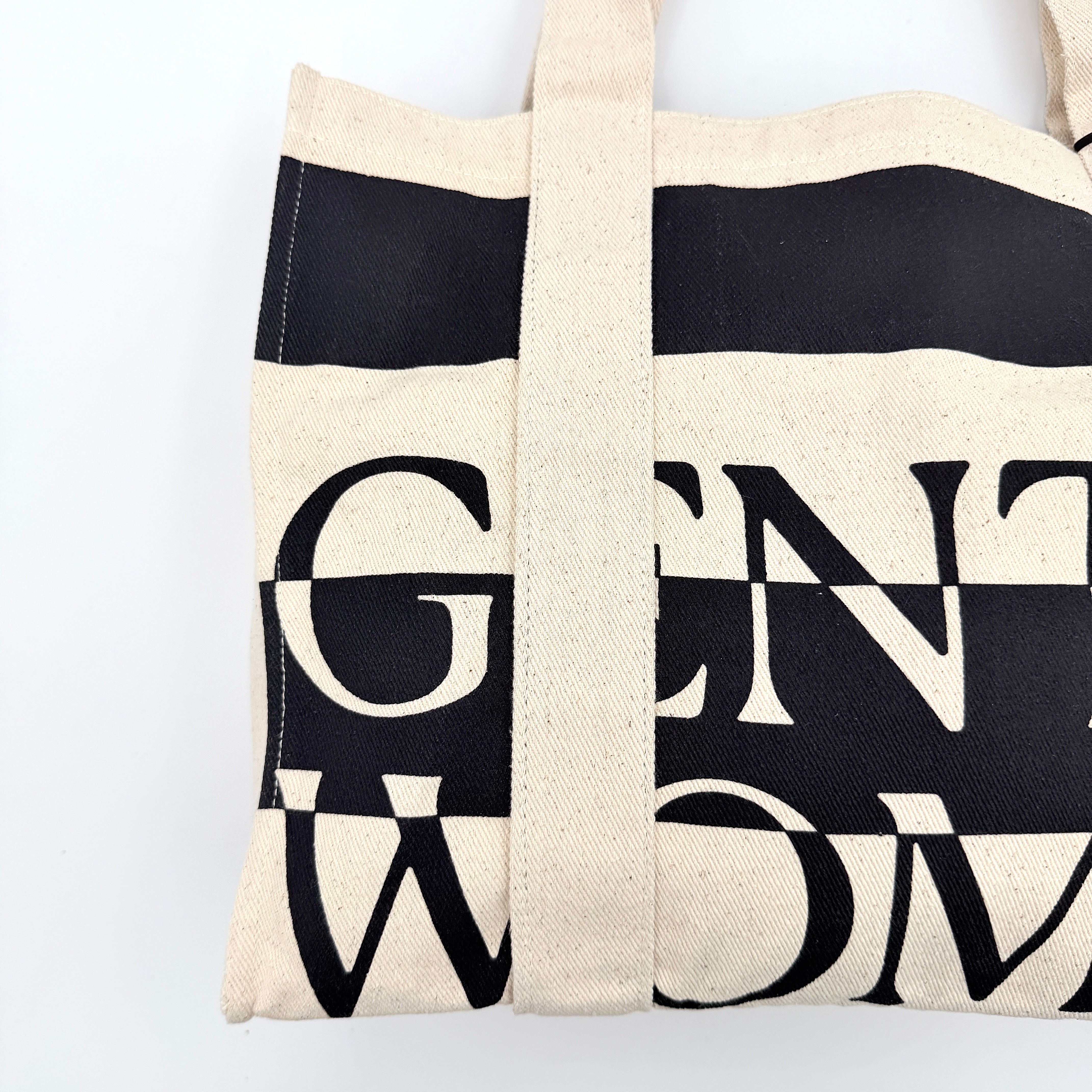 Gentlewoman Canvas Tote Bag in cream and black canvas with bold oversized logo and twin carry handles.