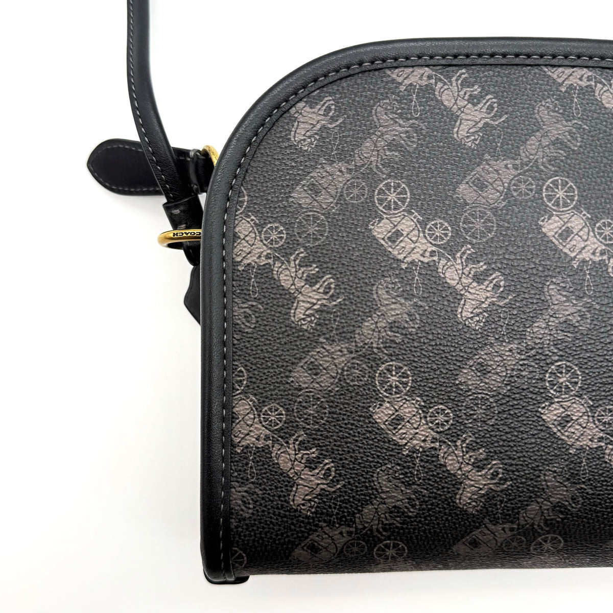 Coach Horse & Carriage Print Zip Crossbody Bag in black coated canvas with adjustable strap and gold hardware.