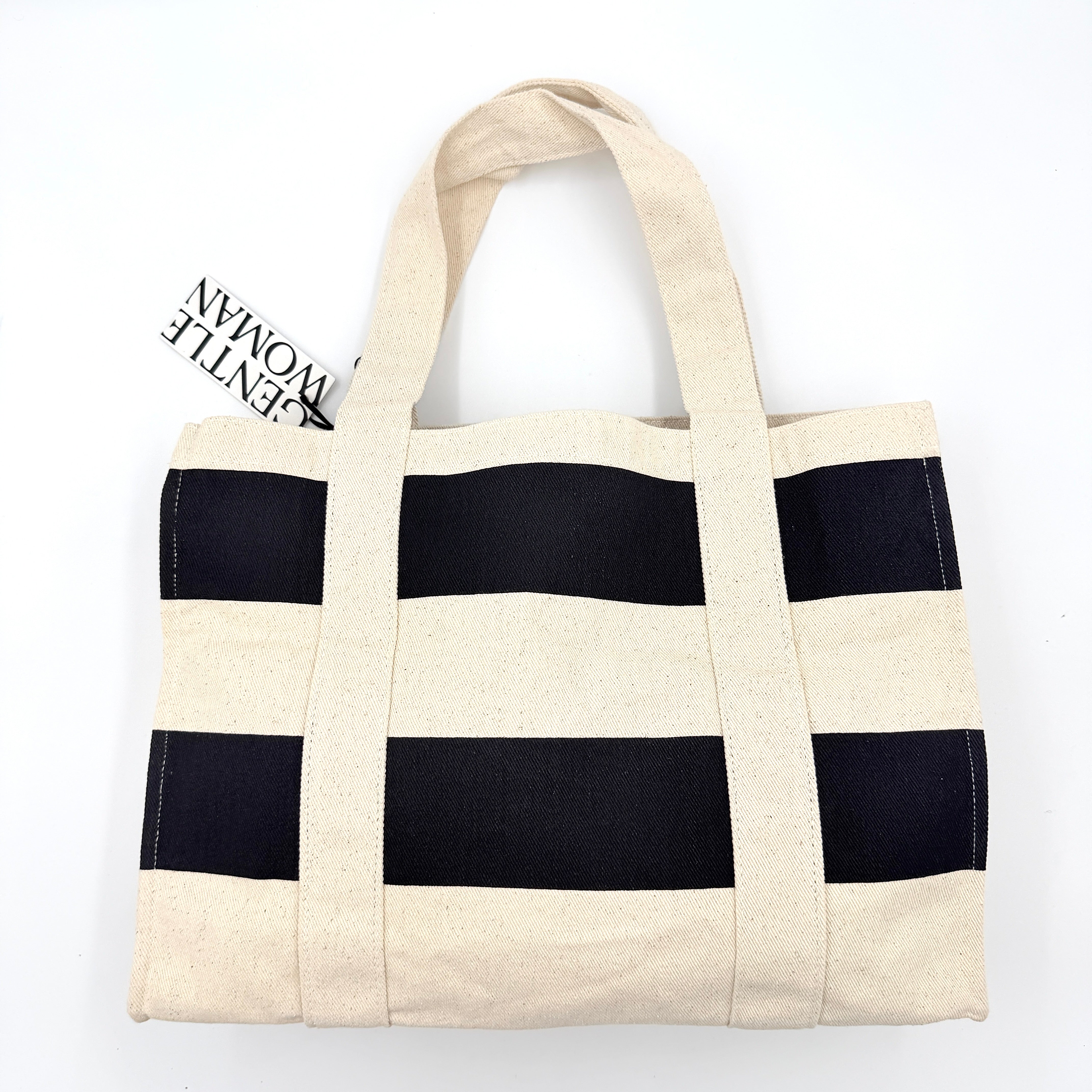 Gentlewoman Canvas Tote Bag in cream and black canvas with bold oversized logo and twin carry handles.