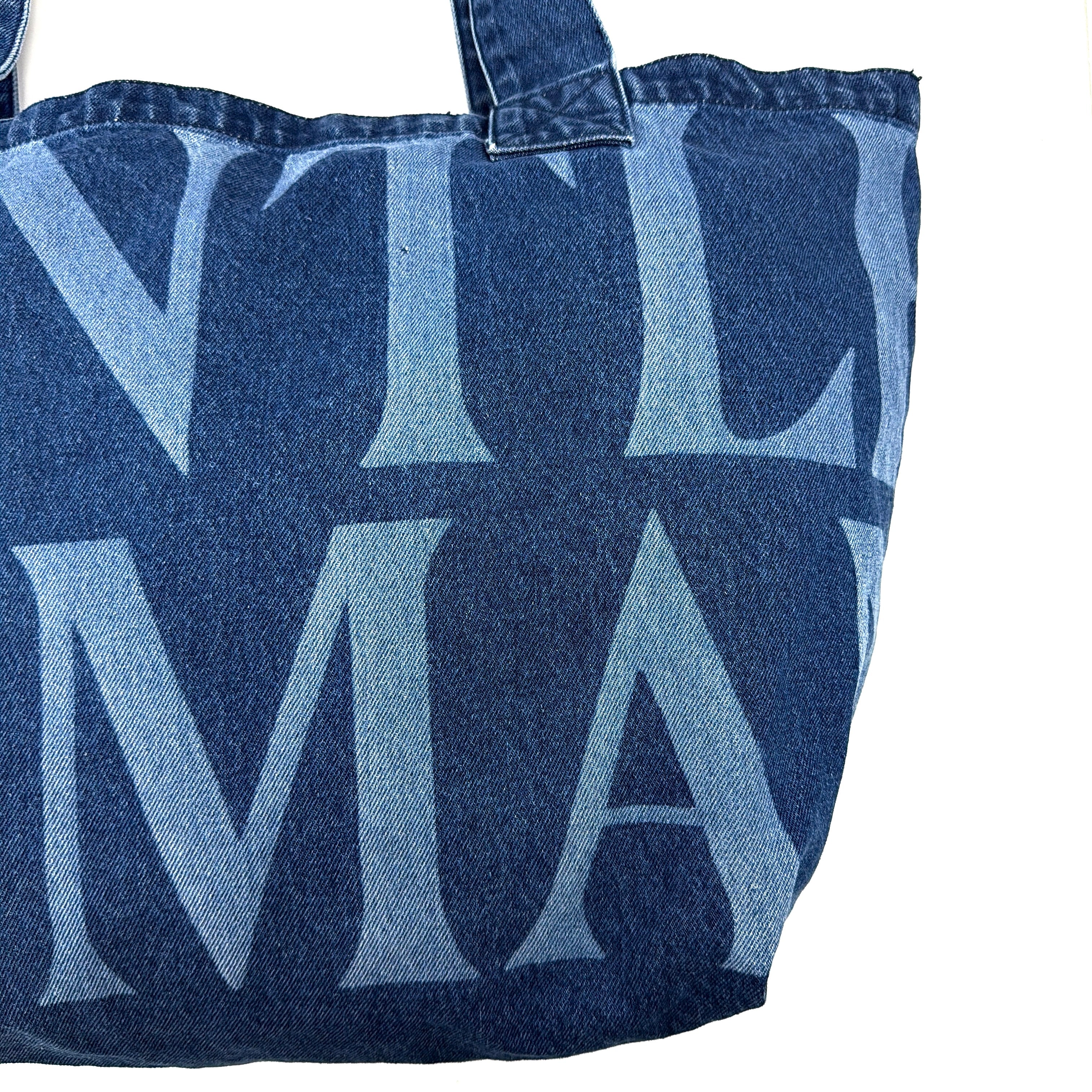 GENTLEWOMAN Jumbo Tote Bag in blue denim with oversized pale blue monogram, featuring sturdy twin handles.