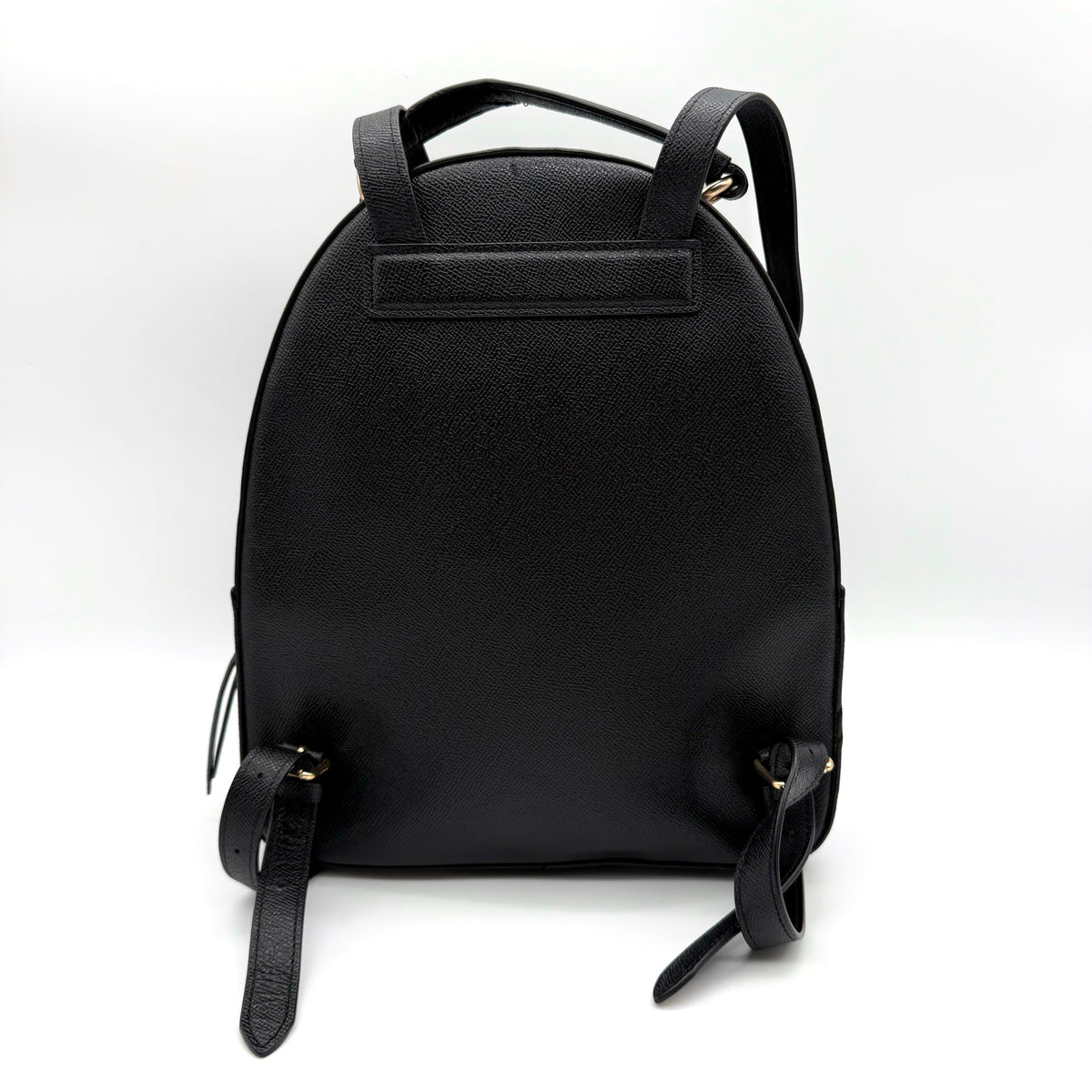 Coach Jordyn Leather Backpack in black grained leather with gold-tone hardware and minimal branding, photographed on white background.
