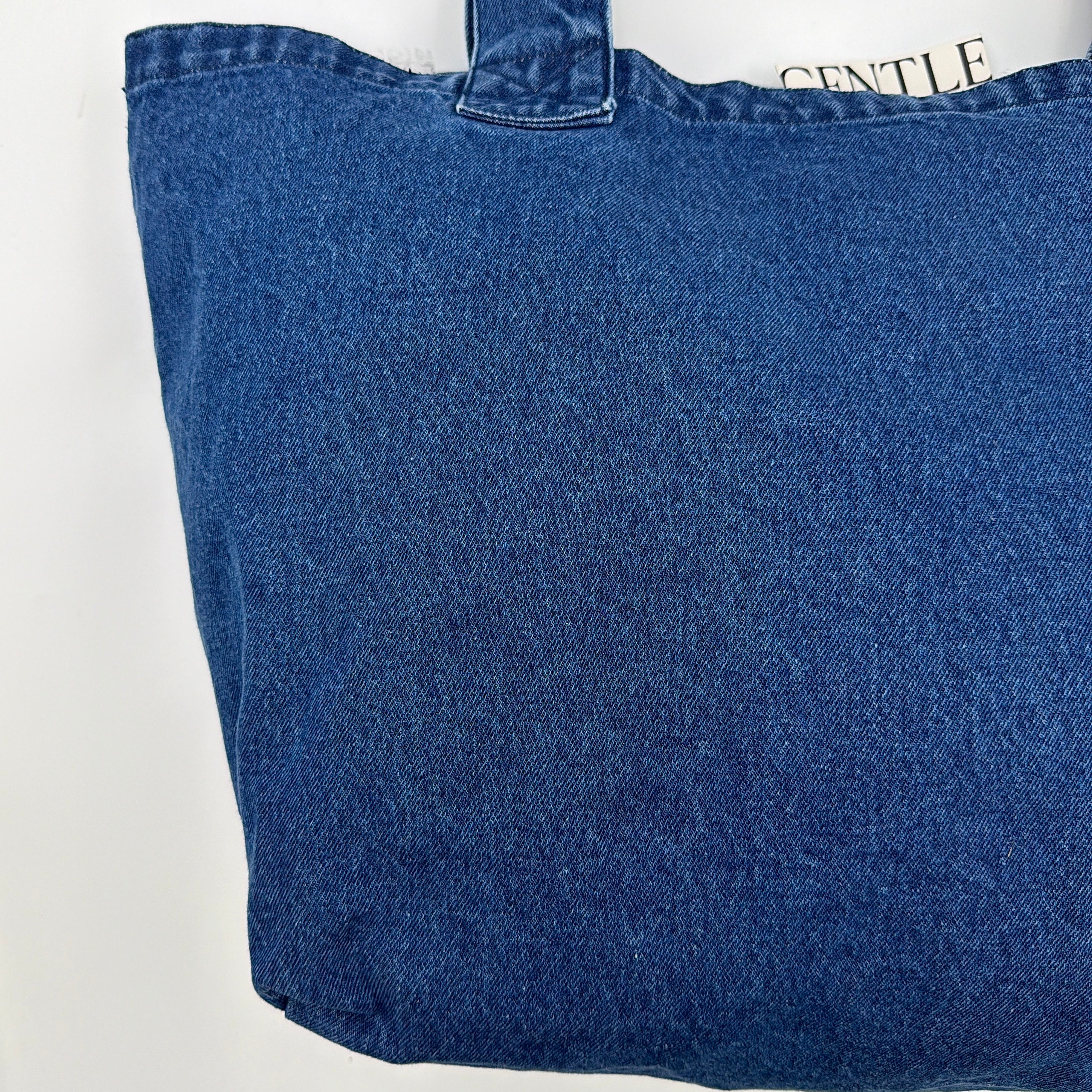 GENTLEWOMAN Jumbo Tote Bag in blue denim with oversized pale blue monogram, featuring sturdy twin handles.
