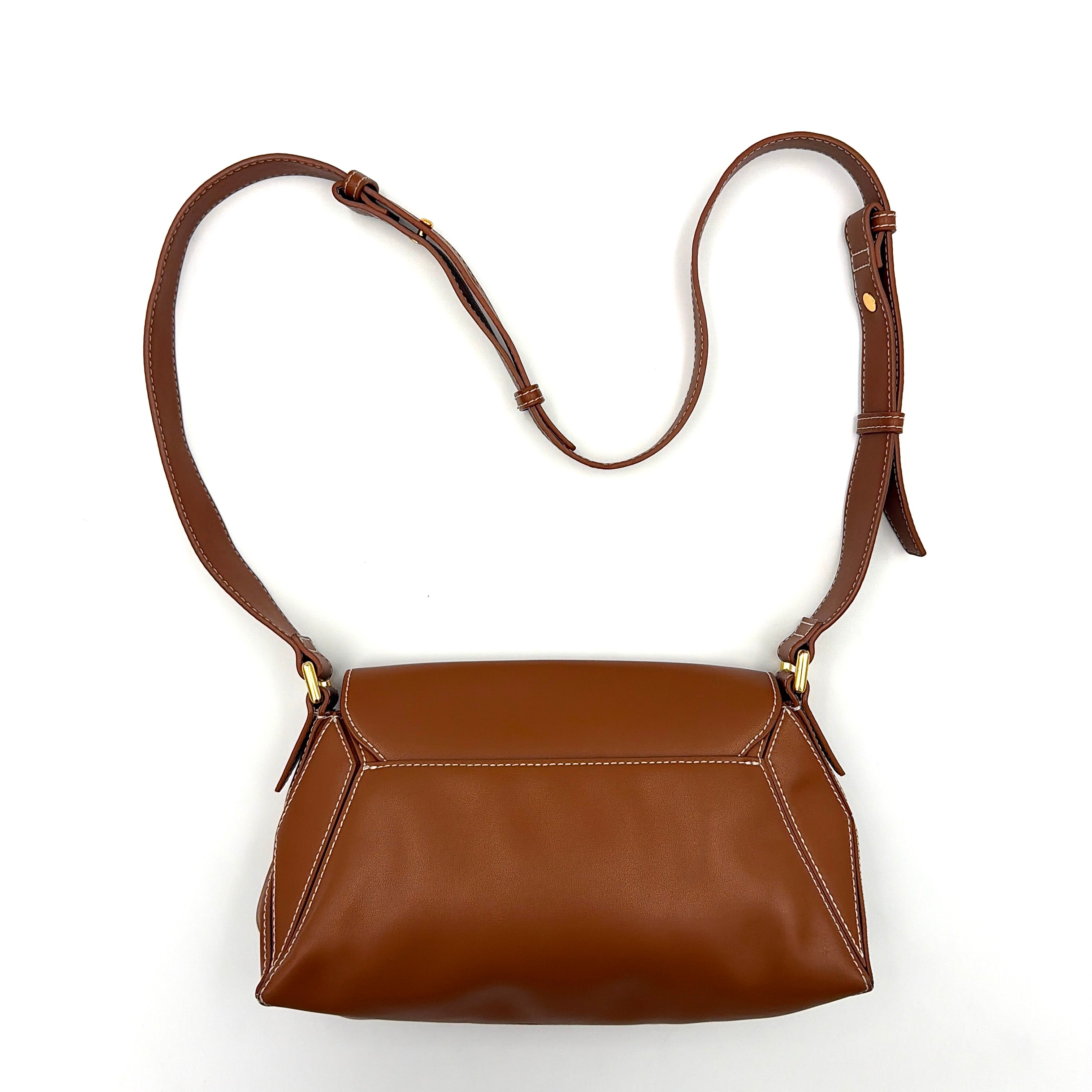 Charles & Keith Nasrin Geometric Crossbody Bag in brown faux leather with angular stitching, gold-tone hardware, and adjustable strap.
