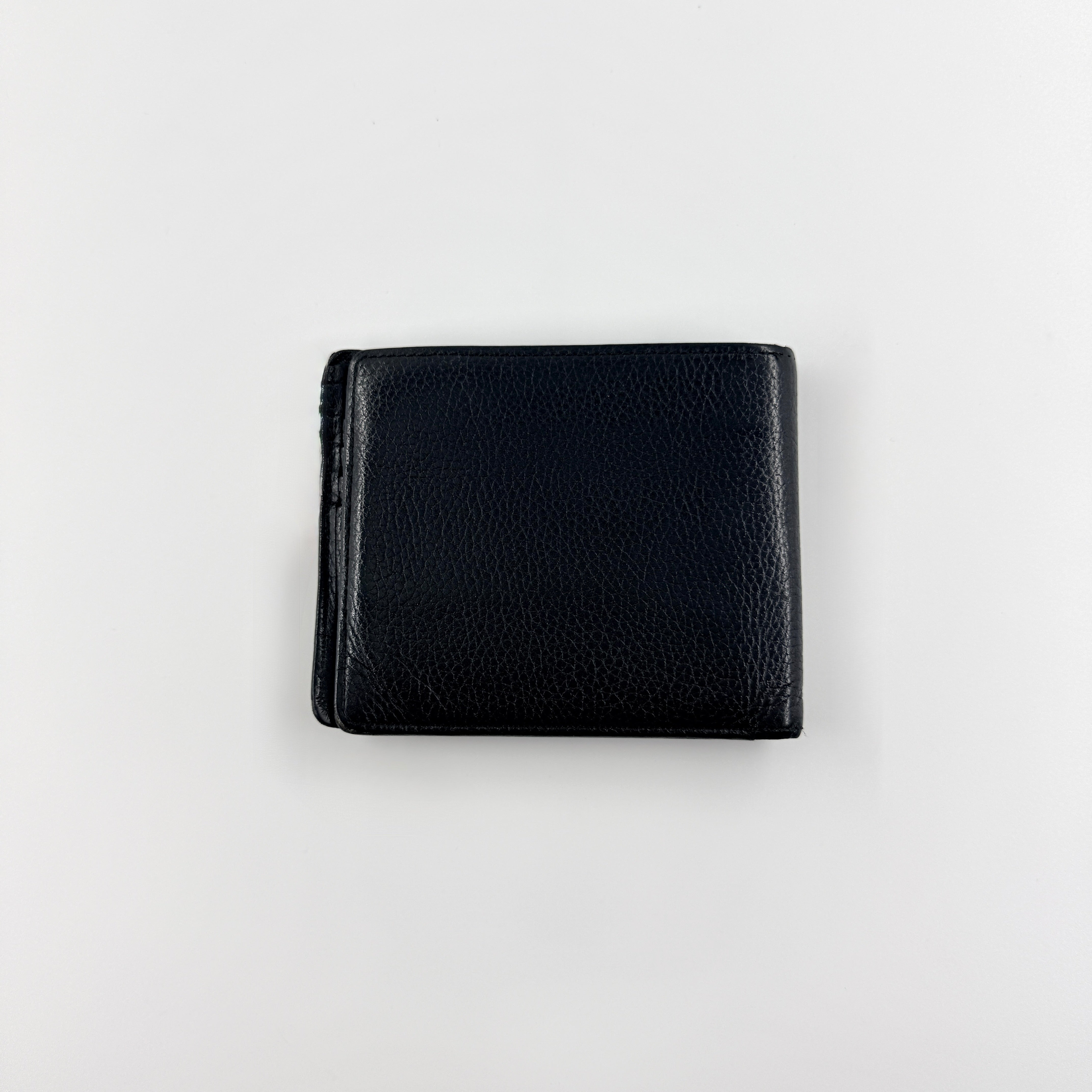 Burberry Nova Check bifold wallet in refined black grained leather with discreet embossed logo, presenting a minimal and polished silhouette.