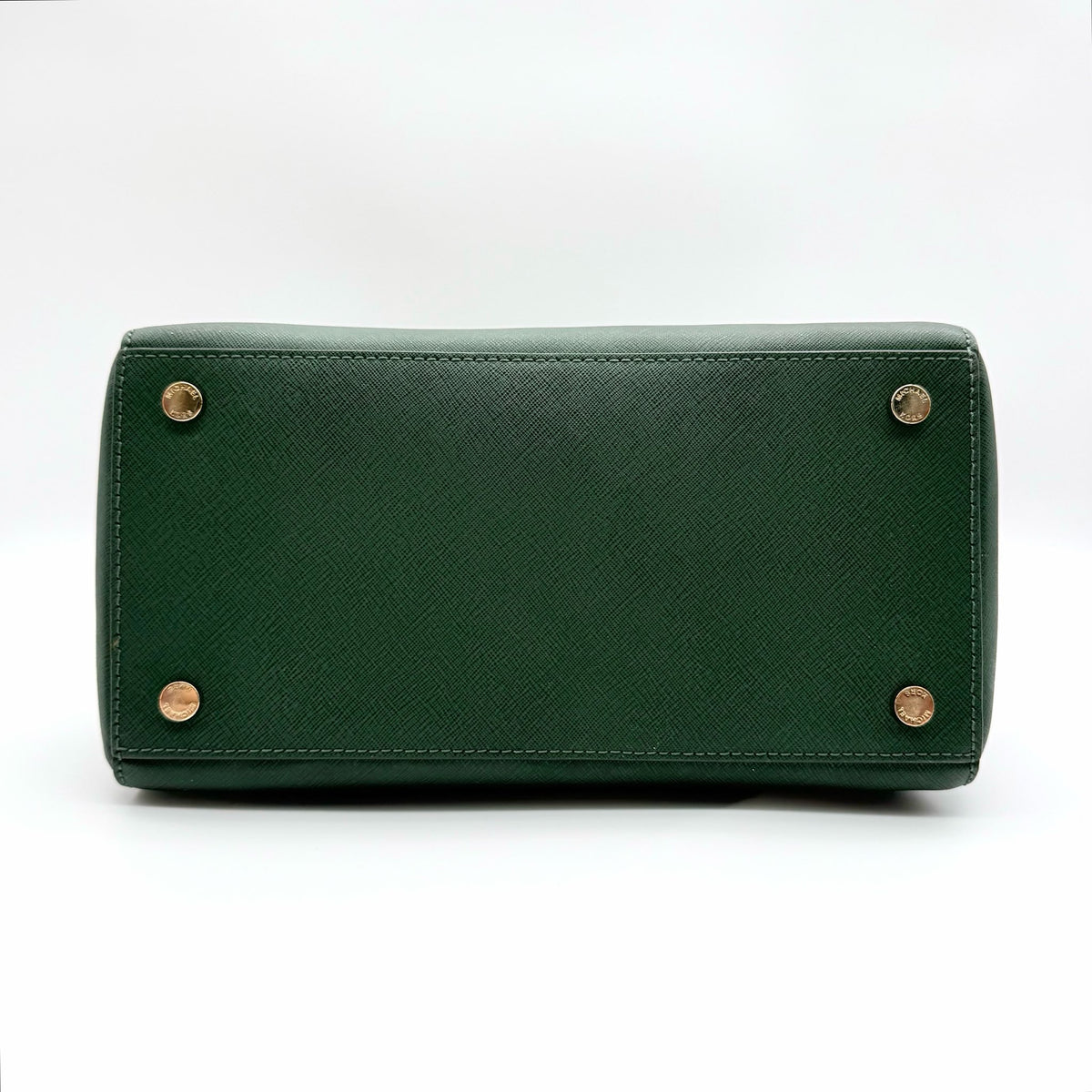 Michael Kors dark green Saffiano leather dome satchel with gold hardware and detachable strap, shown against a white background.