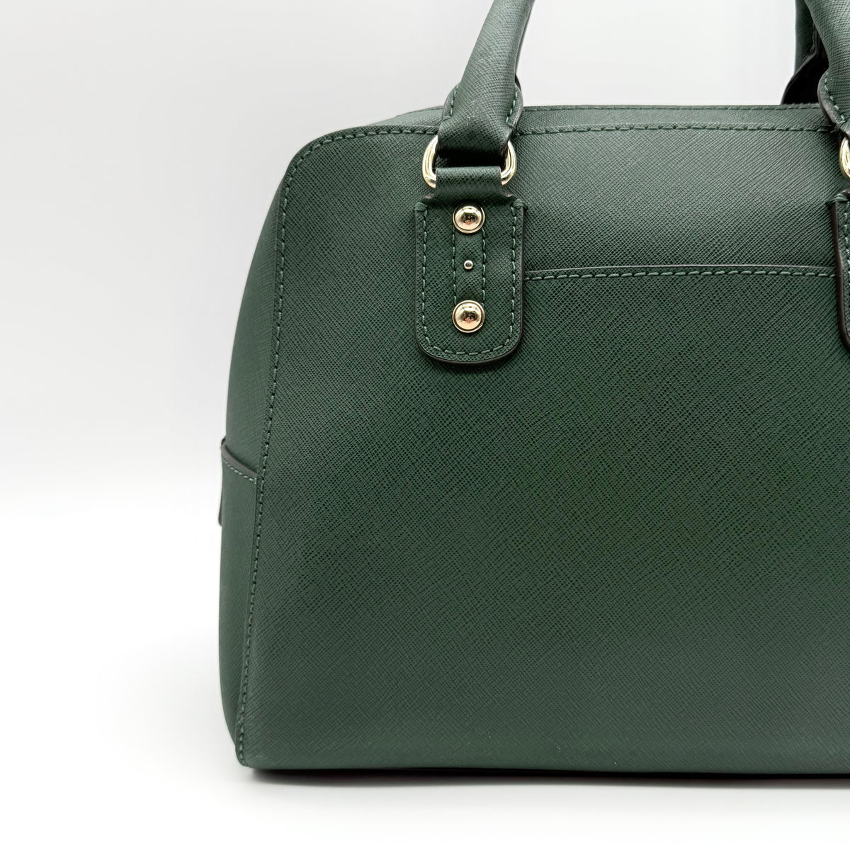 Michael Kors dark green Saffiano leather dome satchel with gold hardware and detachable strap, shown against a white background.