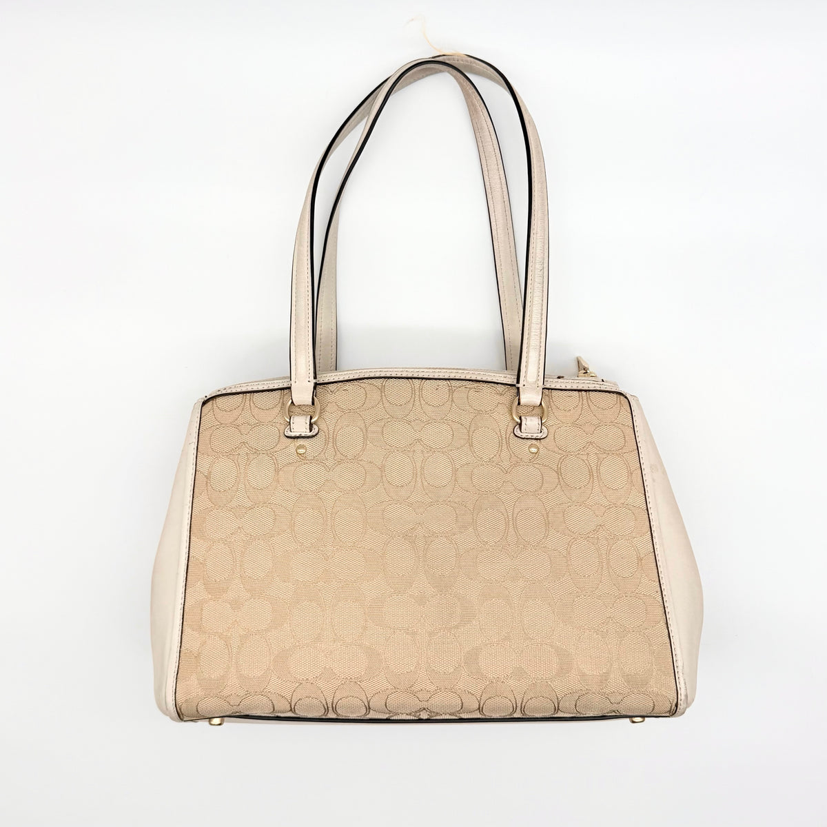 Coach Stanton Carryall in beige and ivory jacquard canvas with gold hardware and detachable strap, styled for everyday versatility.