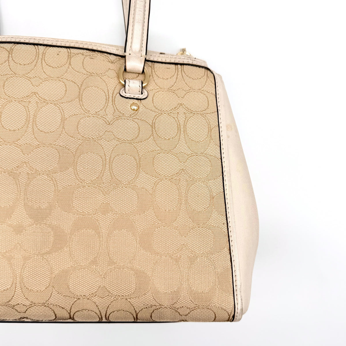 Coach Stanton Carryall in beige and ivory jacquard canvas with gold hardware and detachable strap, styled for everyday versatility.