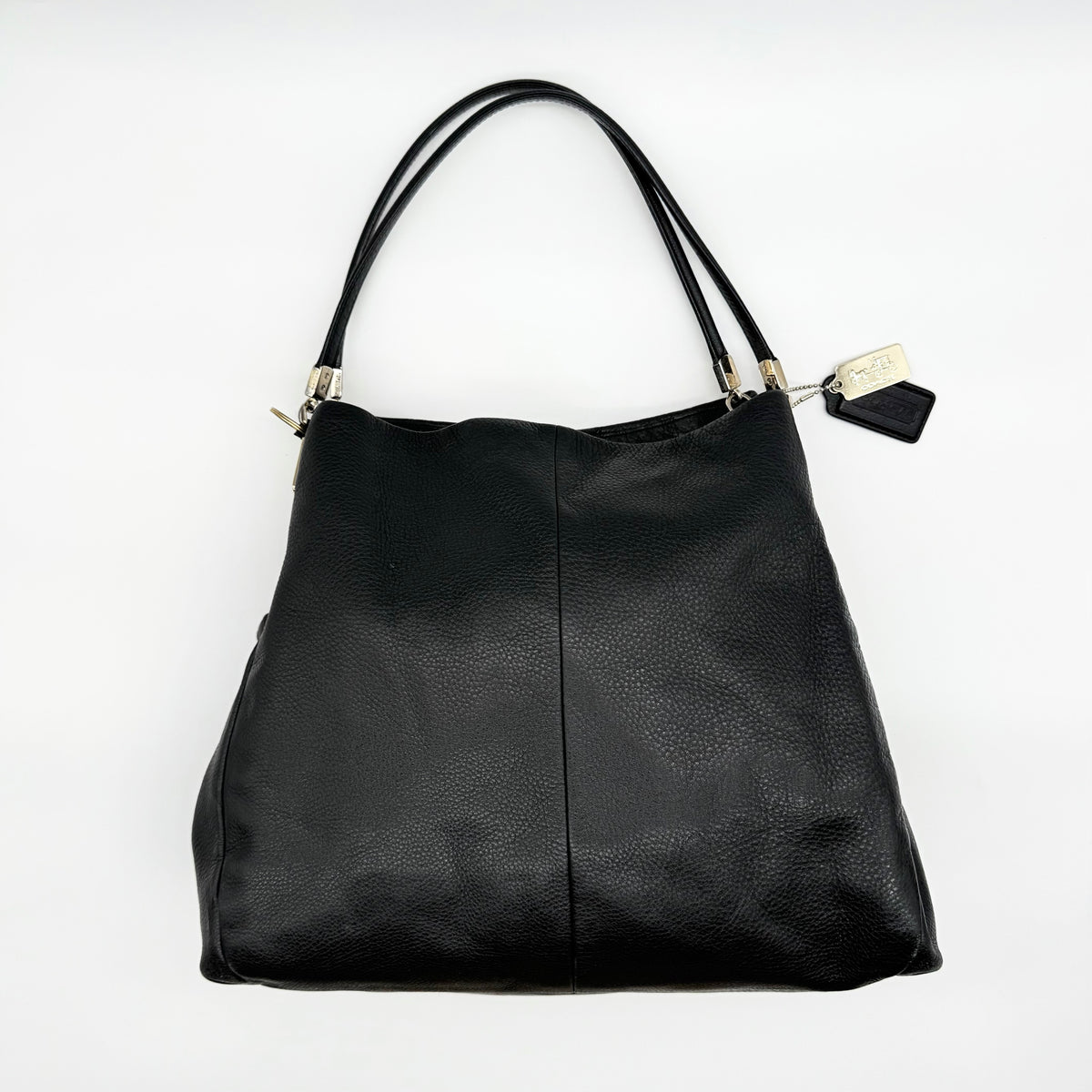 Coach Madison Phoebe Shoulder Bag in black grained leather with gold hardware and dual handles, shown against a white background.