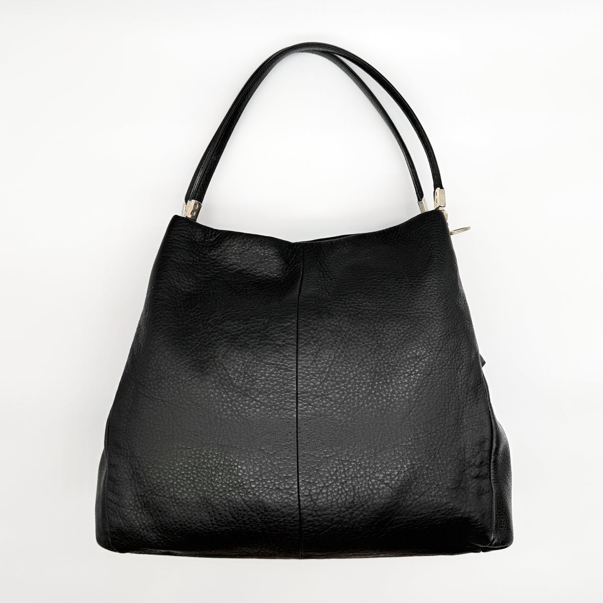 Coach Madison Phoebe Shoulder Bag in black grained leather with gold hardware and dual handles, shown against a white background.