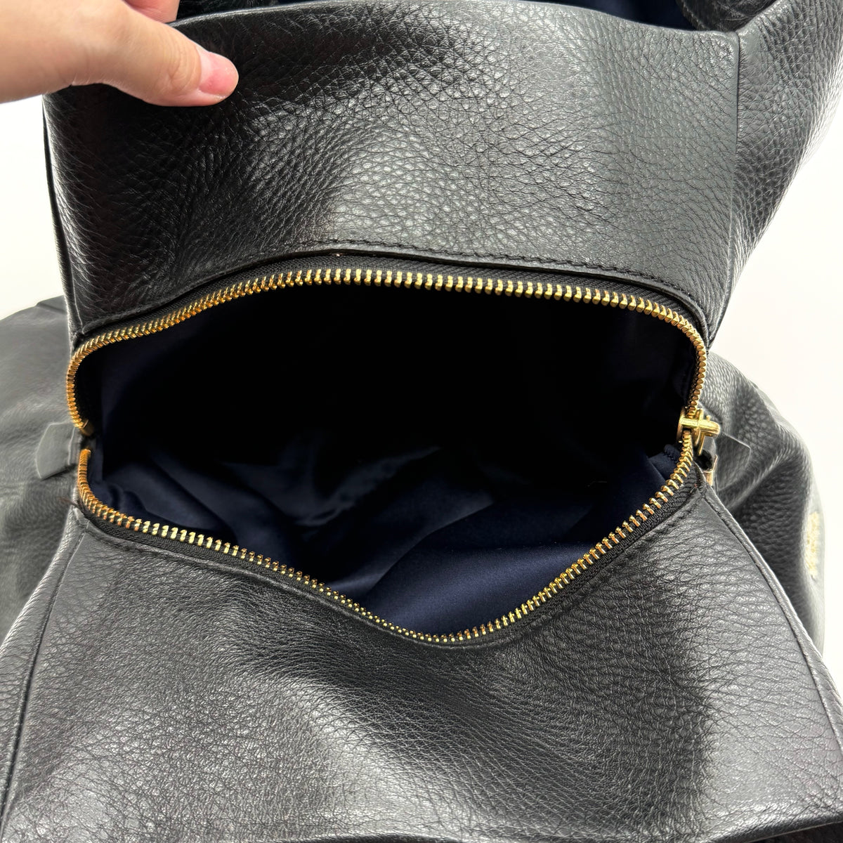 Coach Madison Phoebe Shoulder Bag in black grained leather with gold hardware and dual handles, shown against a white background.