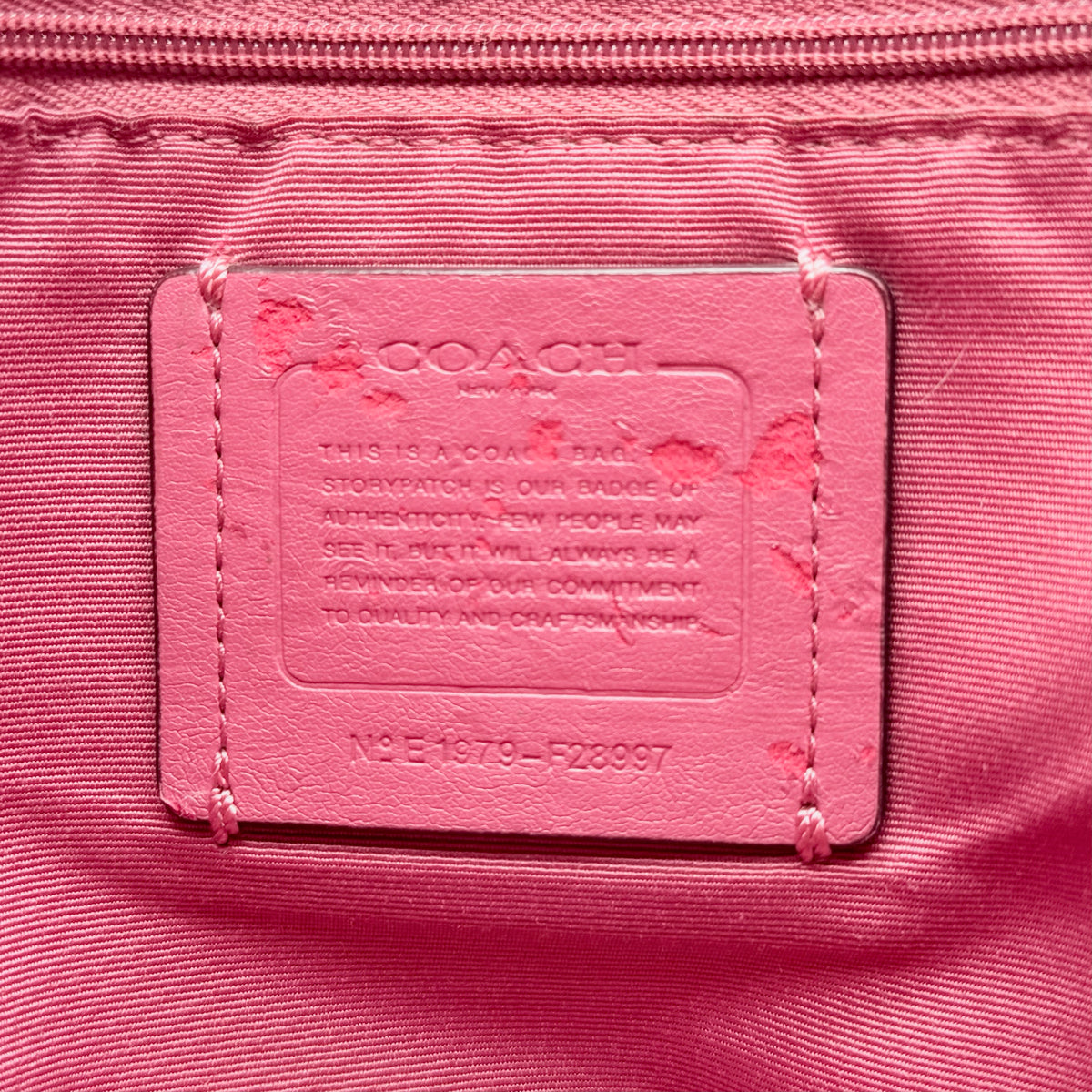 Coach Lexy Shoulder Bag in pink pebbled leather with gold hardware and dual straps, shown against a white background.