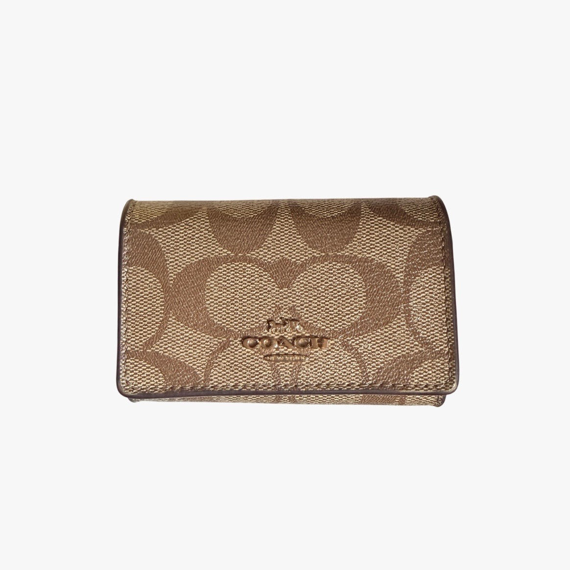 Coach Signature Canvas Key Case in beige with gold-tone logo and signature monogram pattern, shown in a front view.