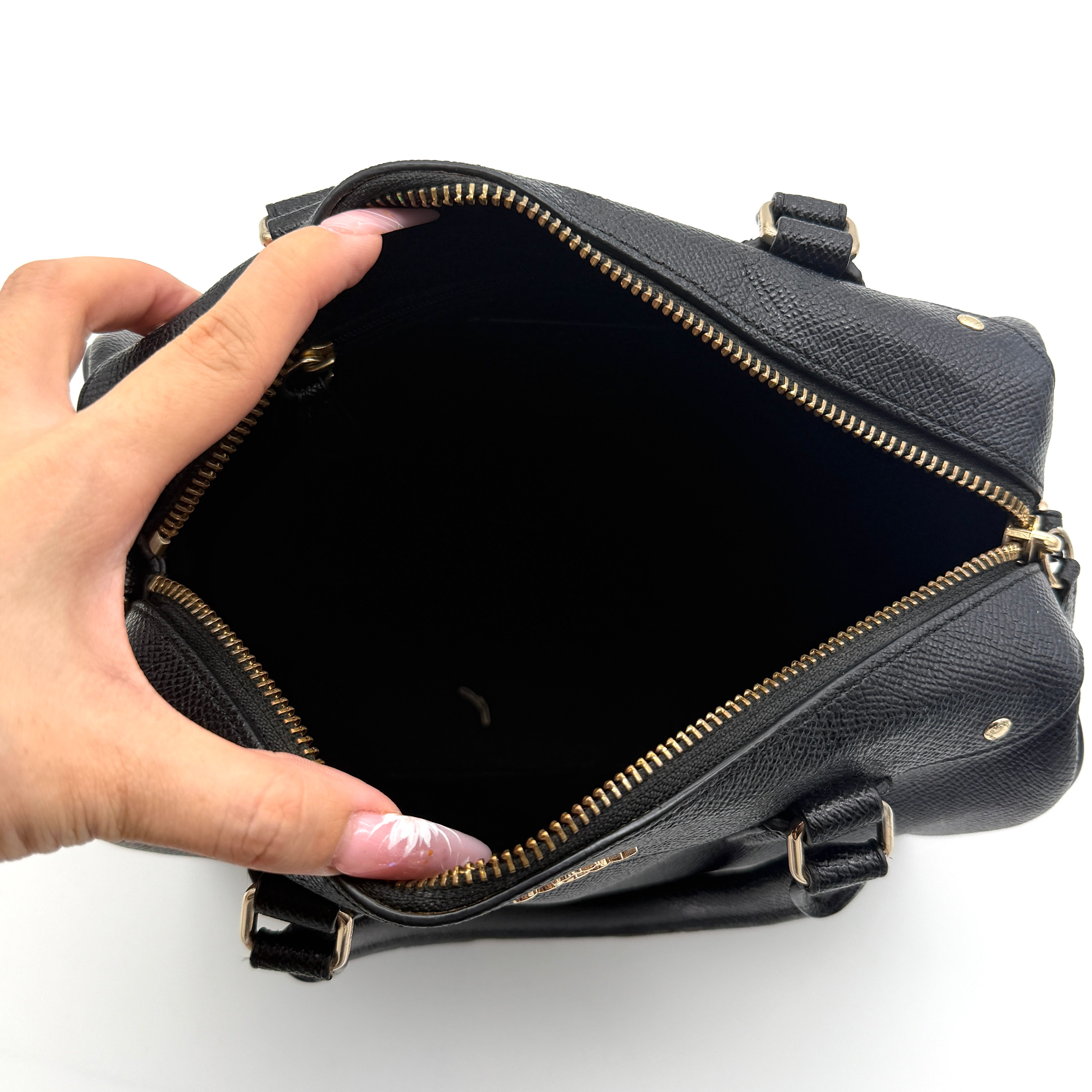 Front-facing image of the Coach Mini Bennett Boston Bag in black grained leather with gold hardware.