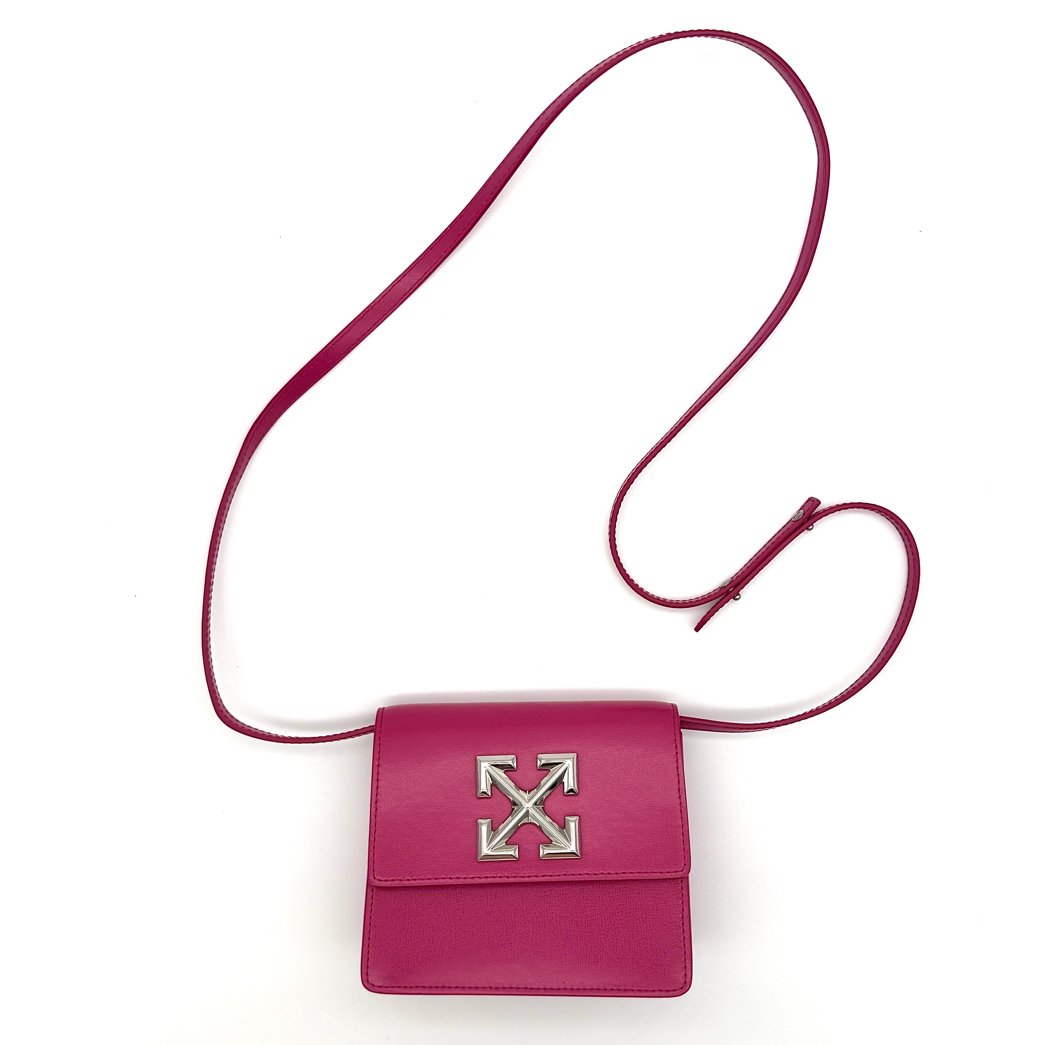 Off-White Jitney 0.7 Crossbody Bag in pink leather with silver-tone arrow logo and adjustable strap, shown against a white background.