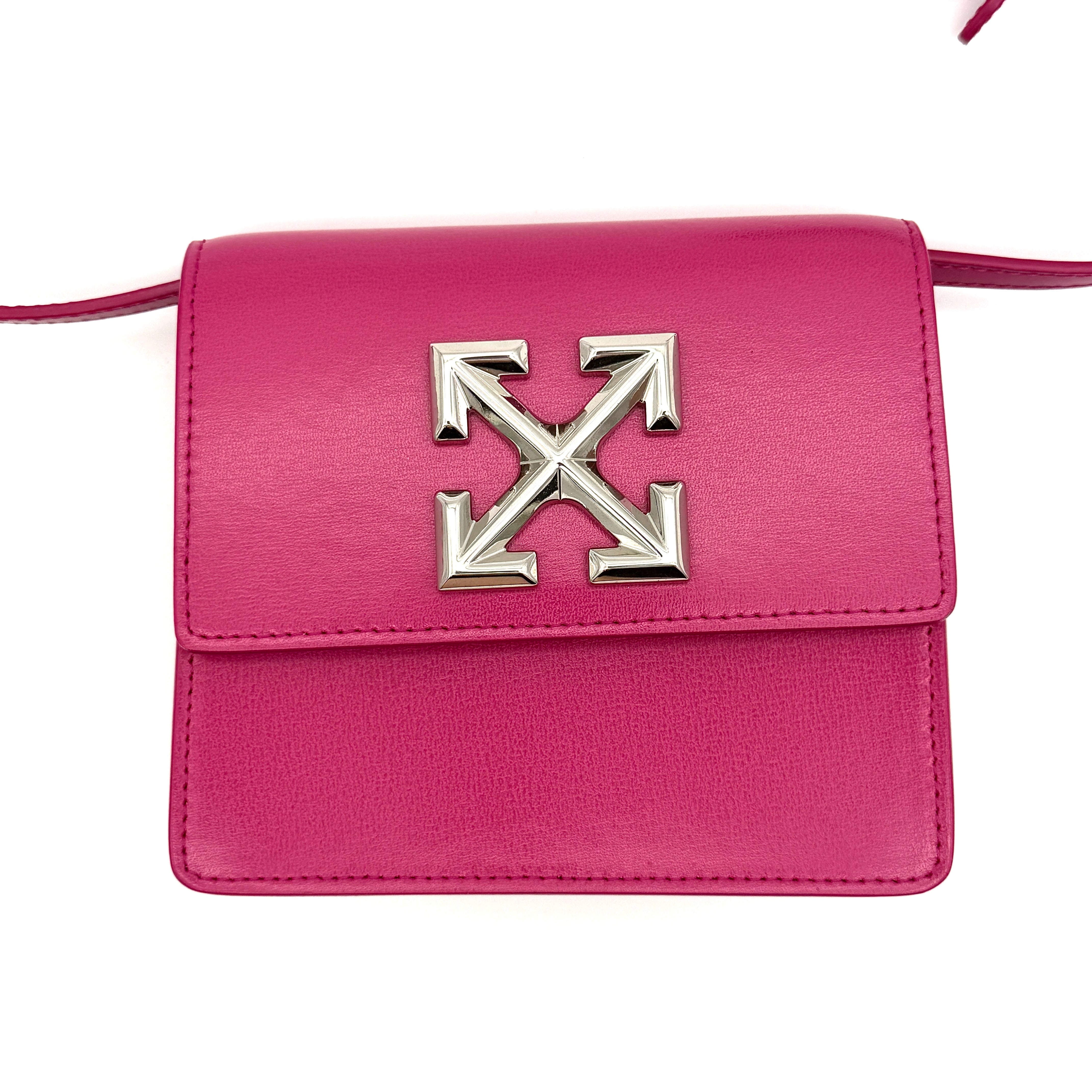 Off-White Jitney 0.7 Crossbody Bag in pink leather with silver-tone arrow logo and adjustable strap, shown against a white background.