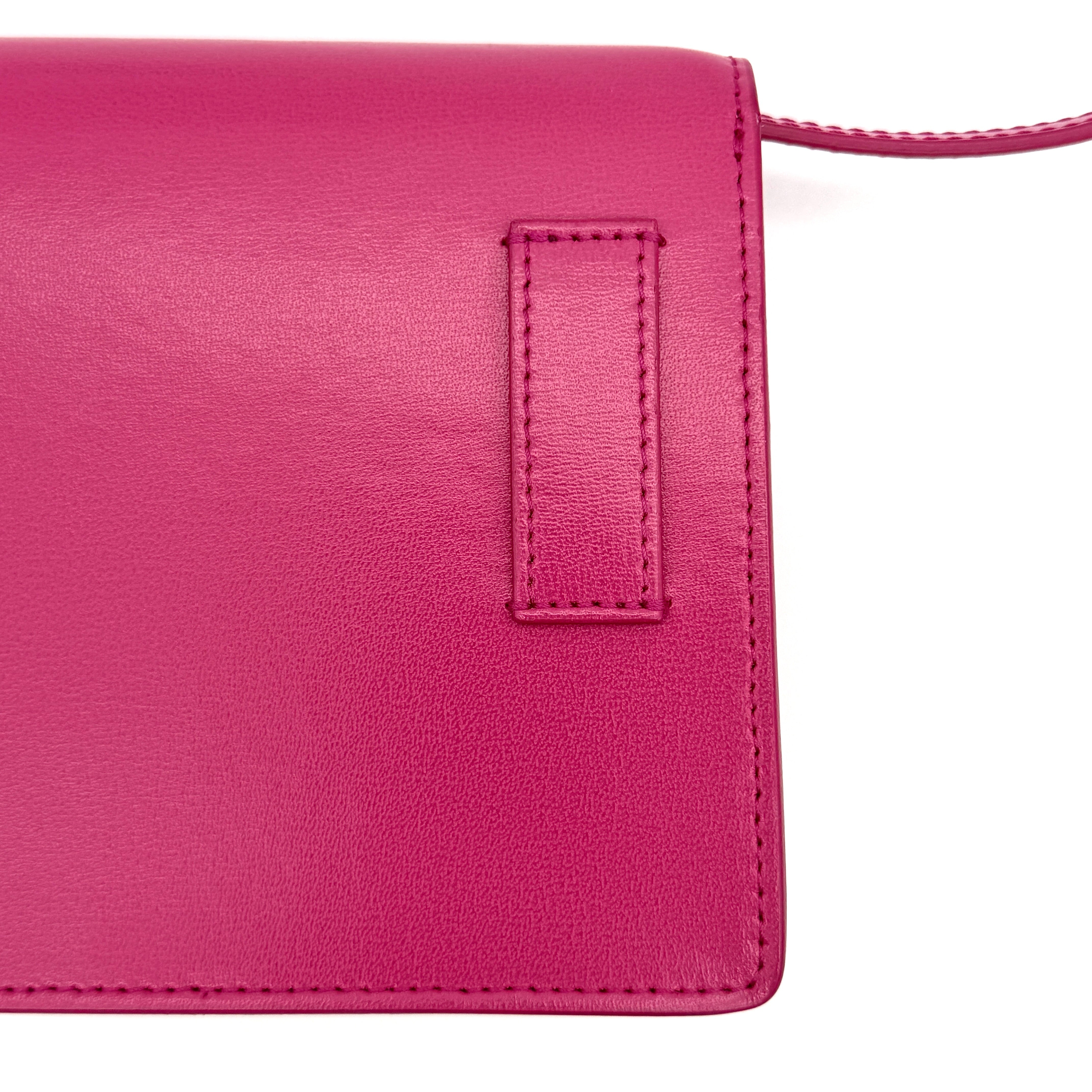 Off-White Jitney 0.7 Crossbody Bag in pink leather with silver-tone arrow logo and adjustable strap, shown against a white background.