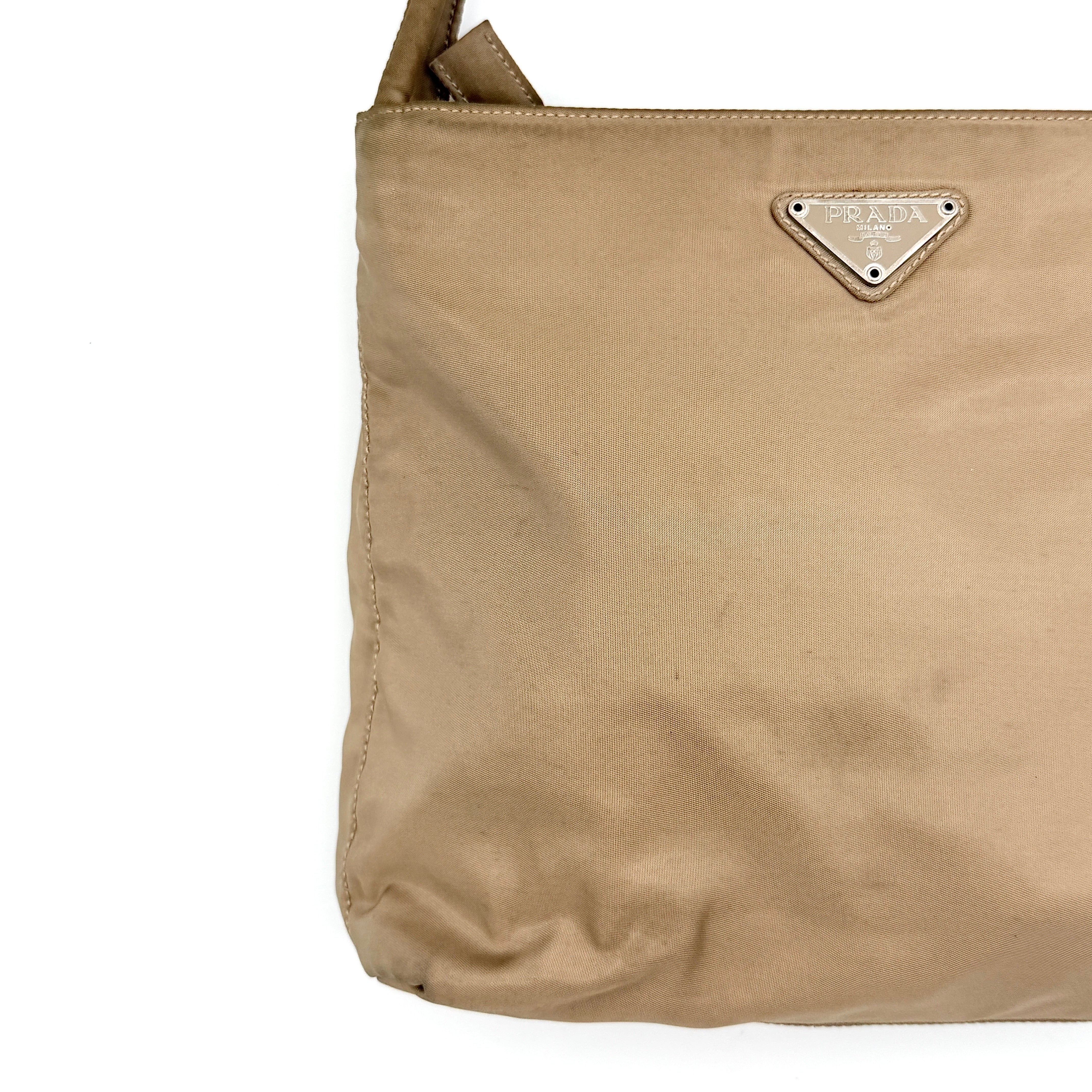 Prada Tessuto nylon tote bag in beige with silver-tone logo plaque and dual handles.