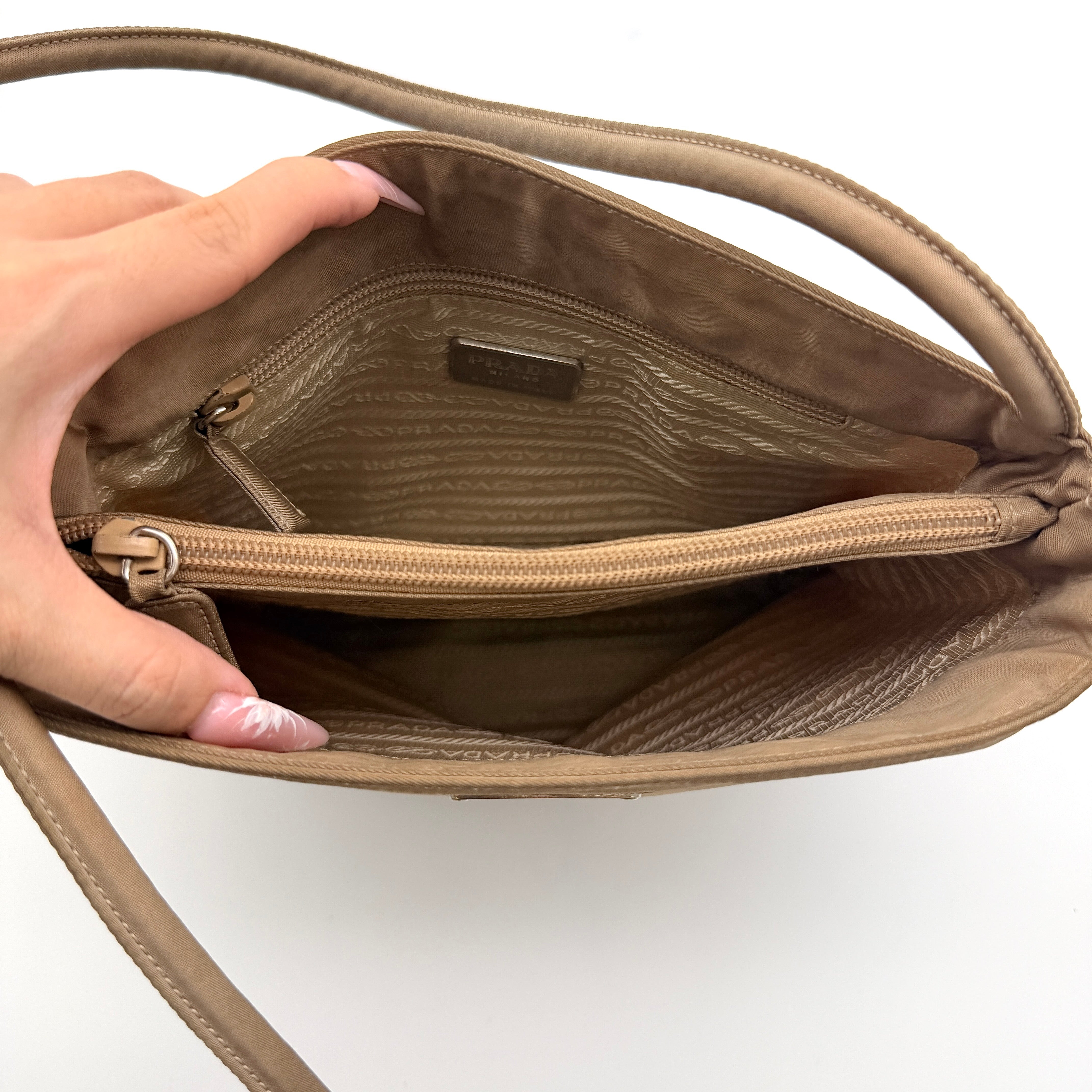 Prada Tessuto nylon tote bag in beige with silver-tone logo plaque and dual handles.