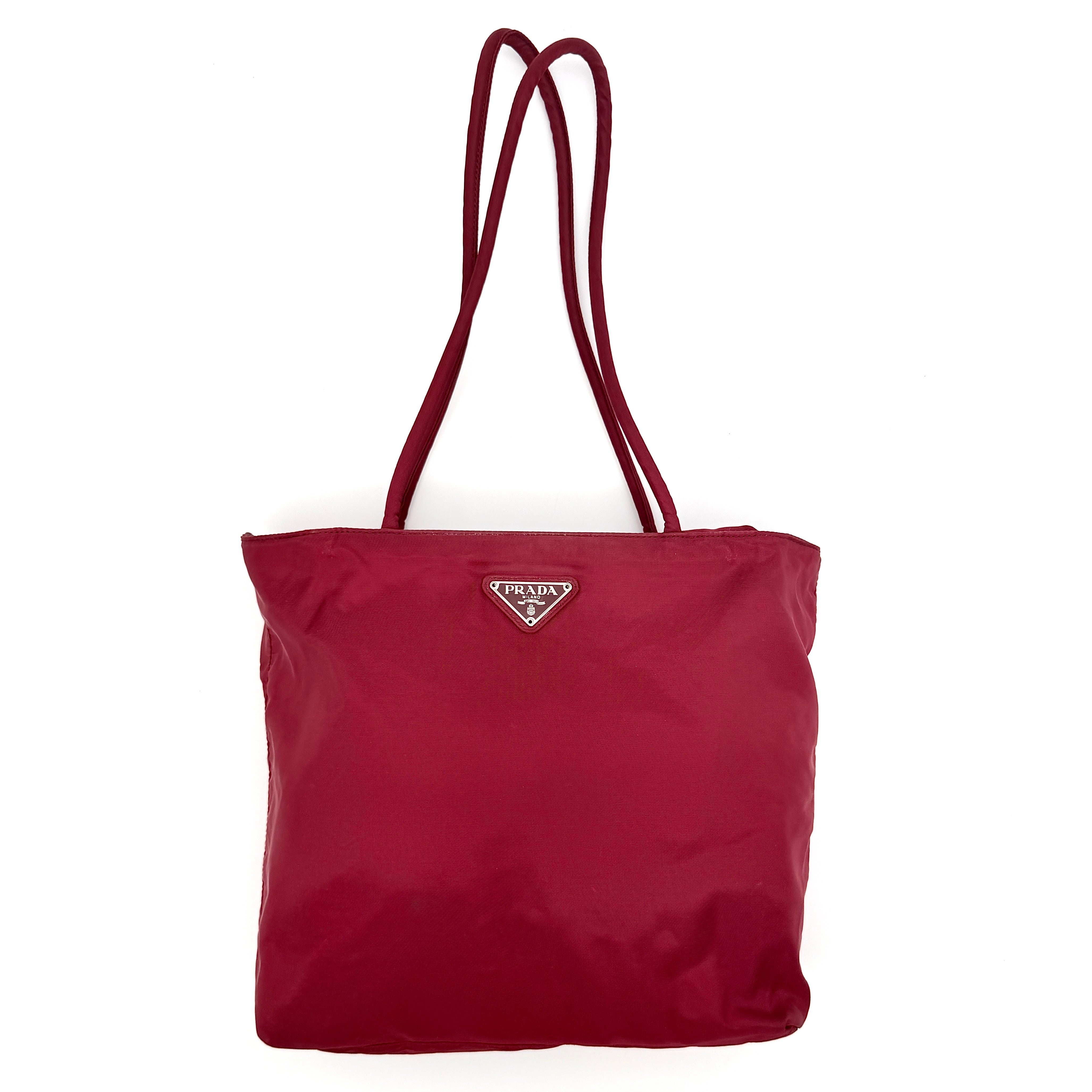 Red Prada Tessuto Nylon Tote Bag with double shoulder straps and classic enamel logo, displayed against a white background.