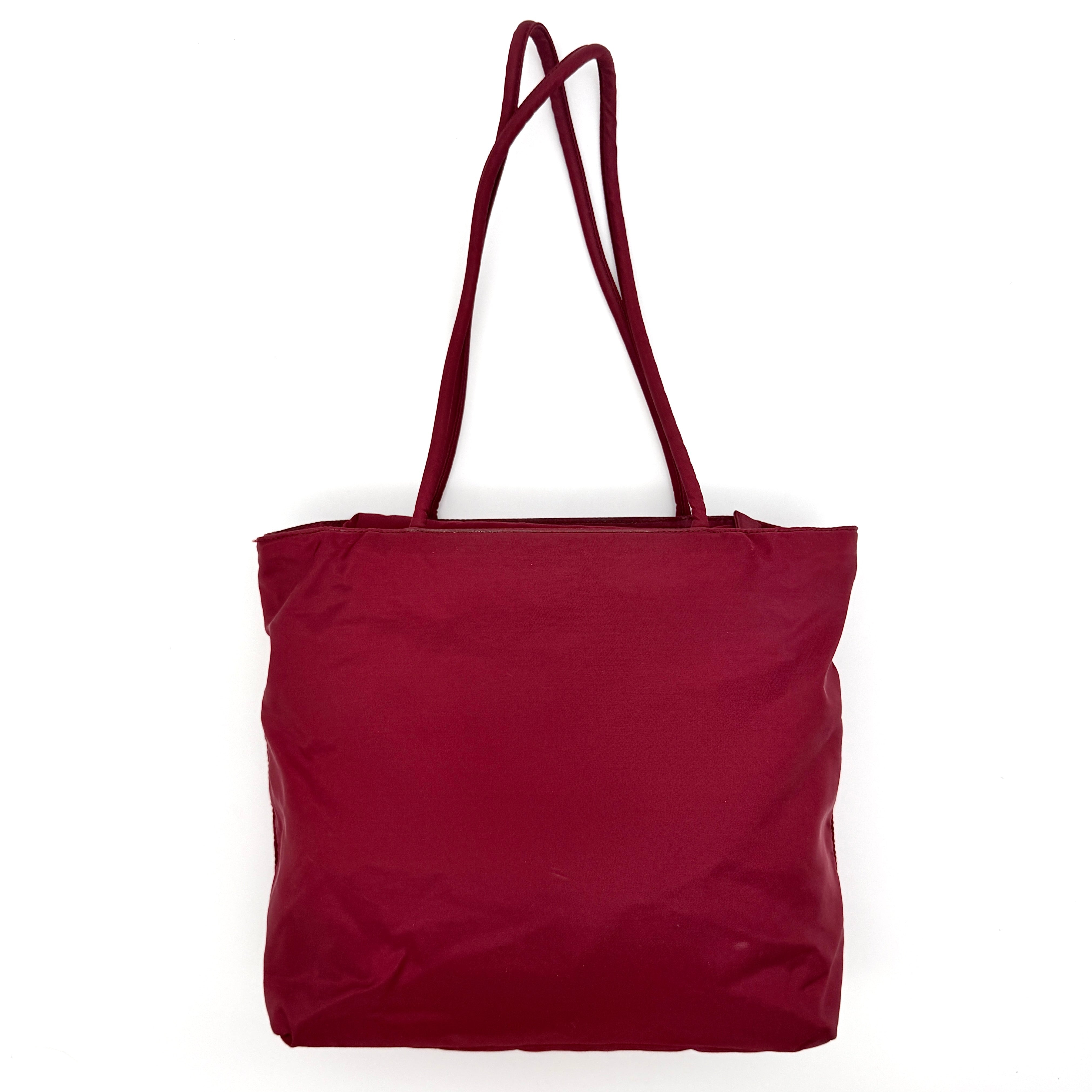 Red Prada Tessuto Nylon Tote Bag with double shoulder straps and classic enamel logo, displayed against a white background.