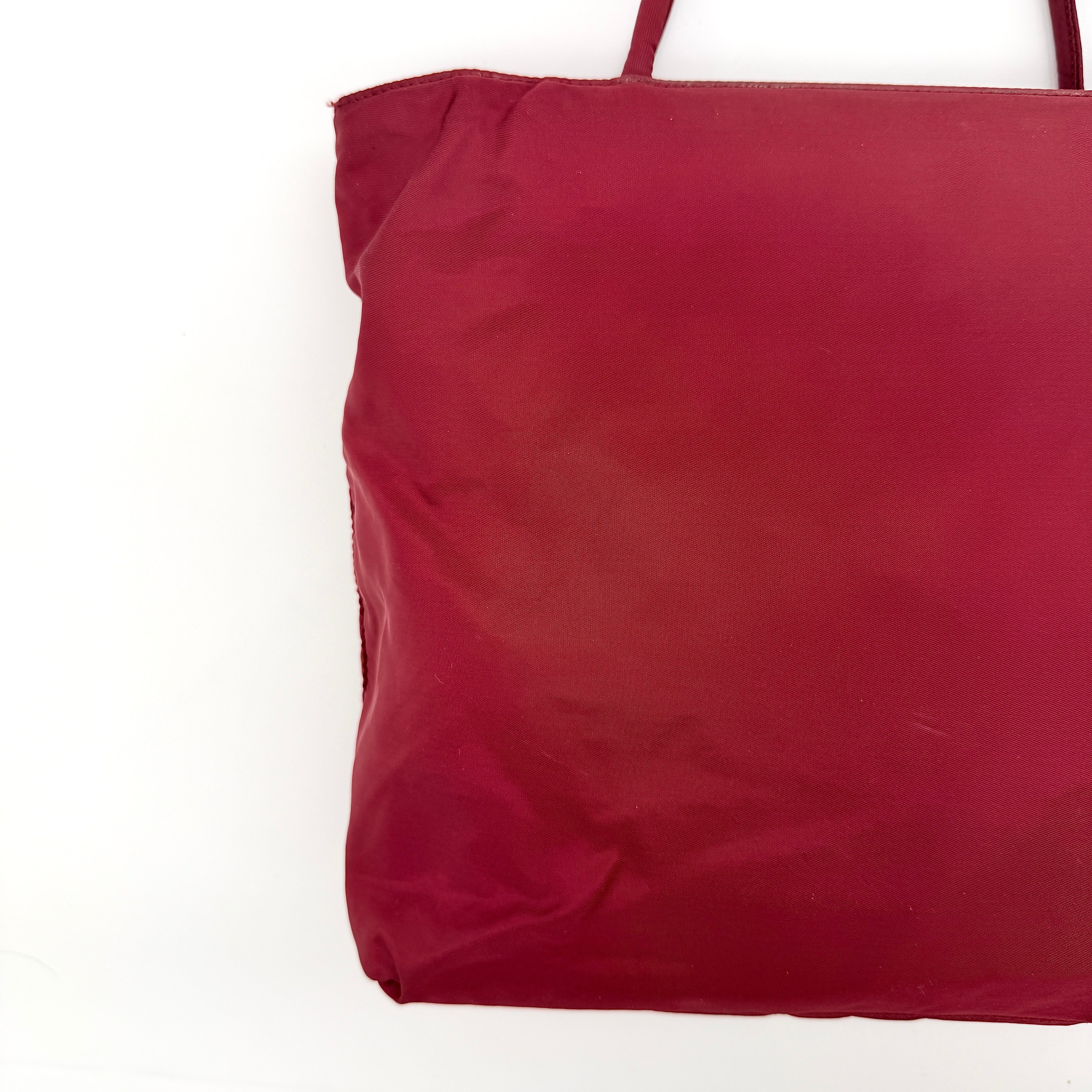 Red Prada Tessuto Nylon Tote Bag with double shoulder straps and classic enamel logo, displayed against a white background.