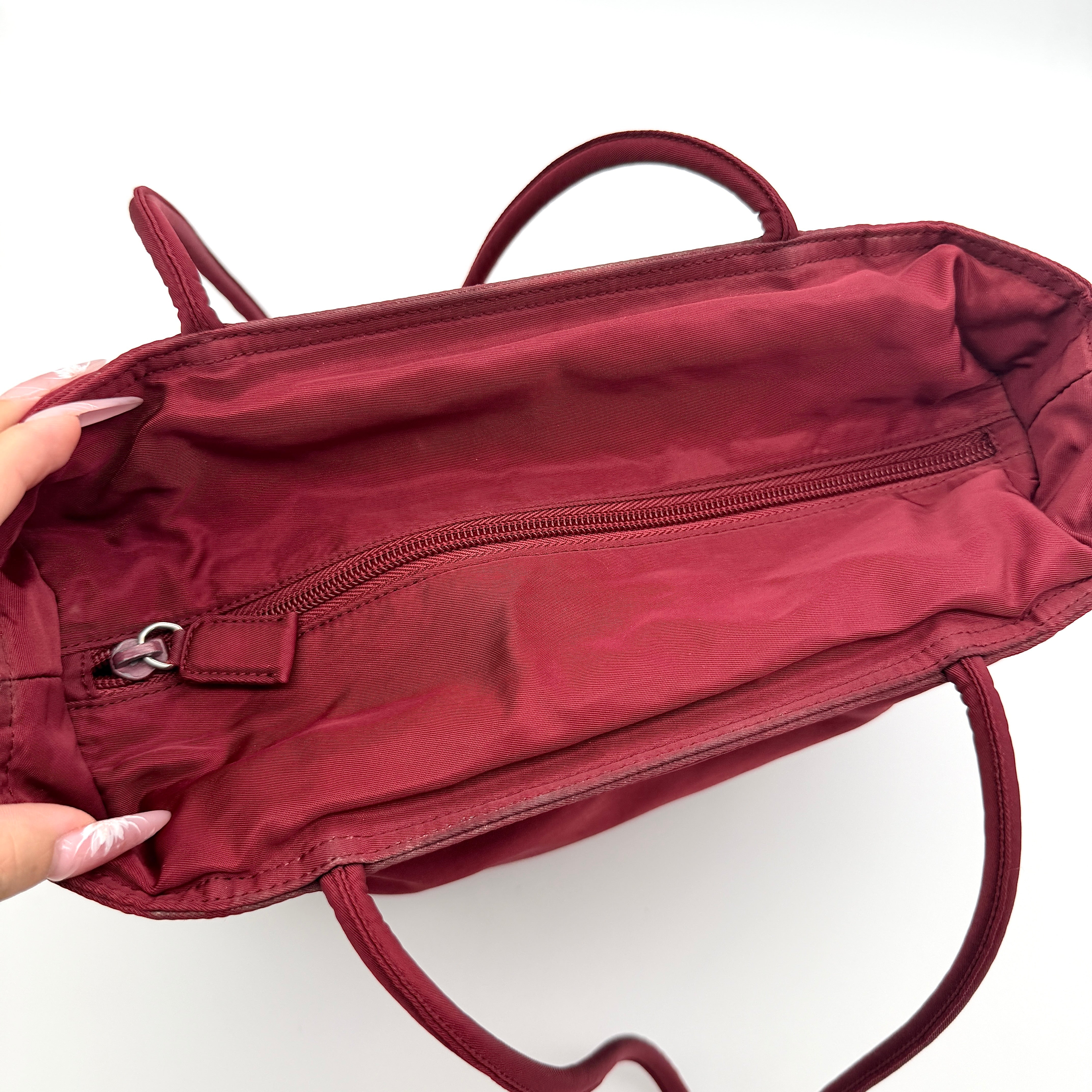 Red Prada Tessuto Nylon Tote Bag with double shoulder straps and classic enamel logo, displayed against a white background.