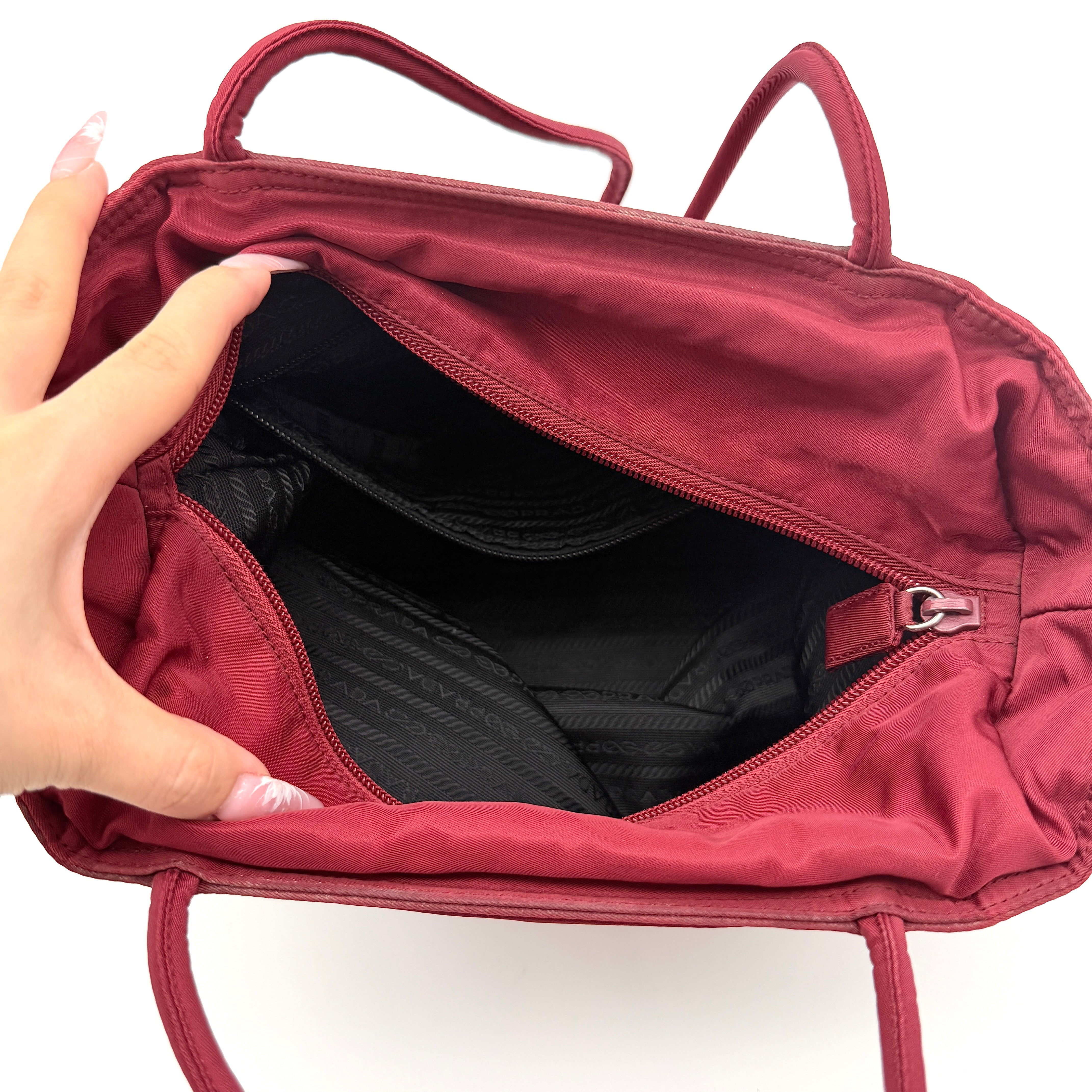 Red Prada Tessuto Nylon Tote Bag with double shoulder straps and classic enamel logo, displayed against a white background.