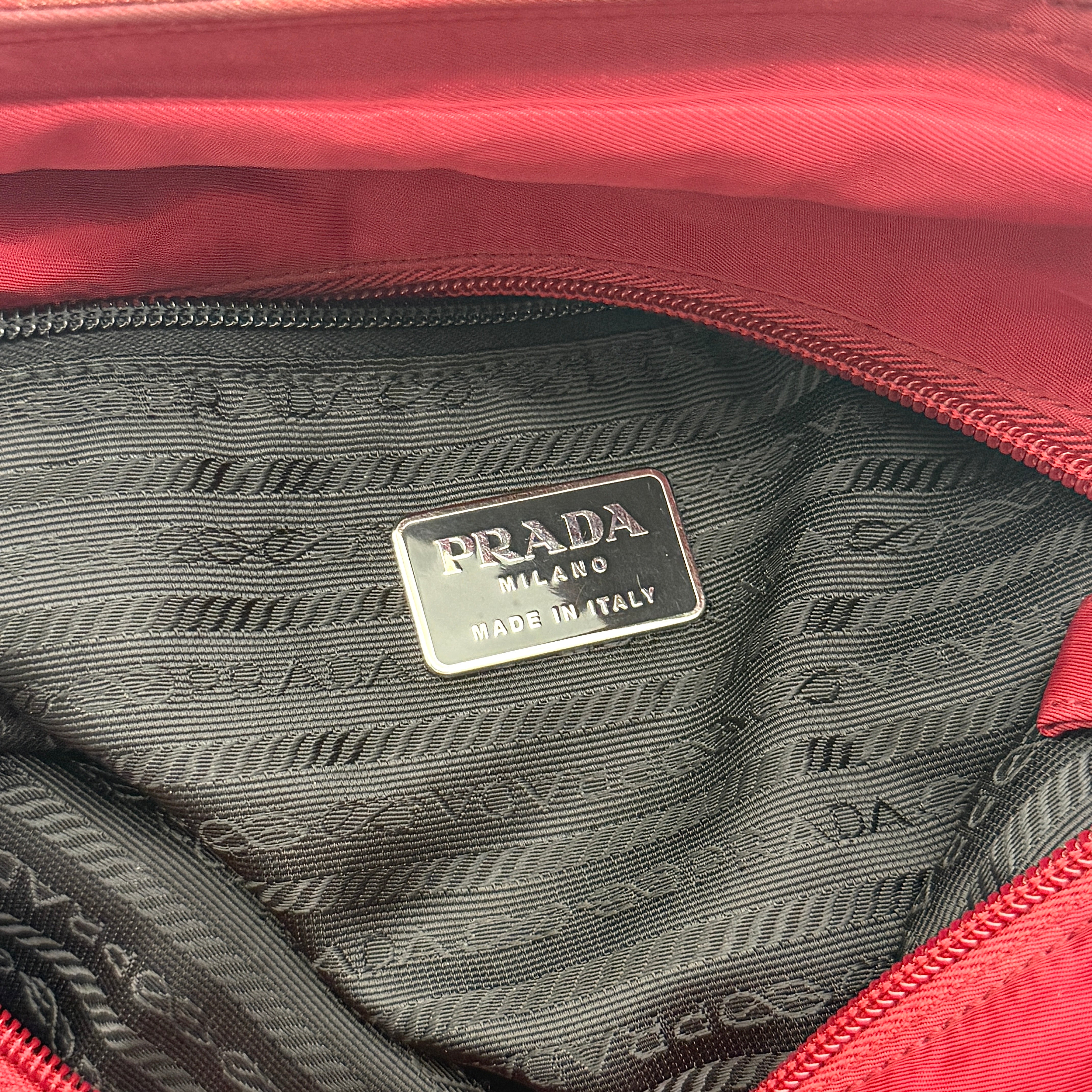 Red Prada Tessuto Nylon Tote Bag with double shoulder straps and classic enamel logo, displayed against a white background.