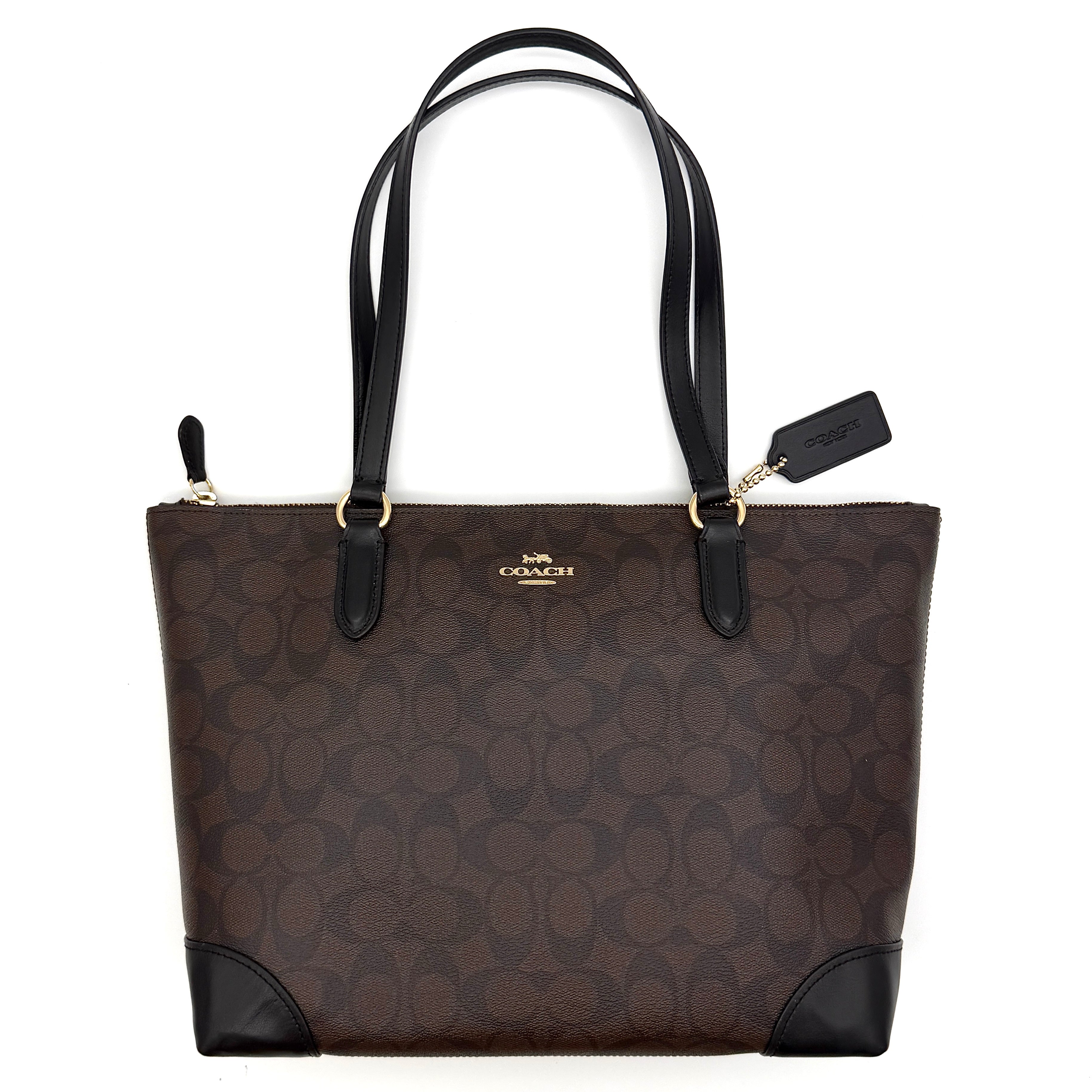 Coach Signature Zip Top Tote Bag in brown and black canvas with leather trim and gold-tone hardware.