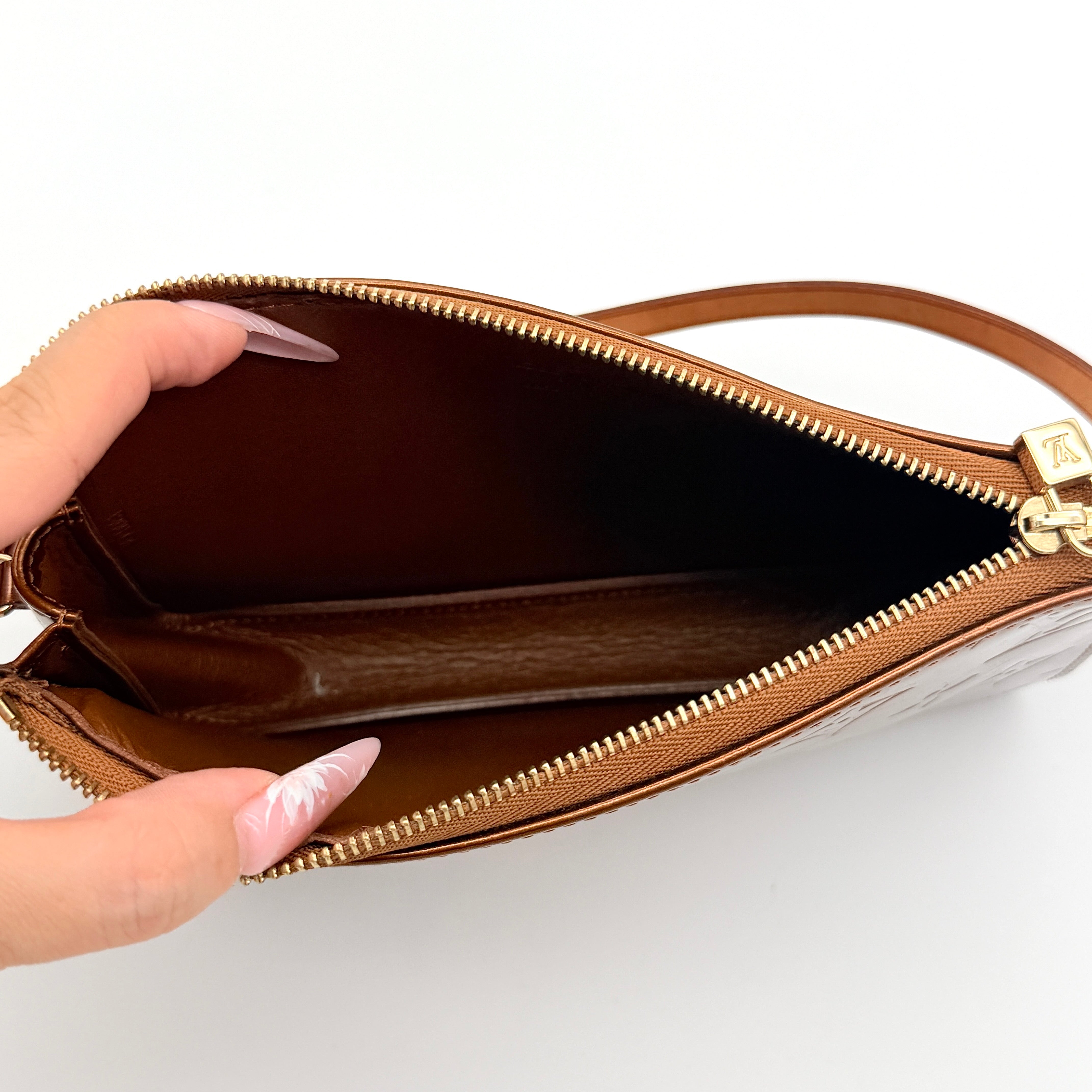 Louis Vuitton Monogram Lexington Vernis Pochette in bronze patent leather, shown with its gold-tone hardware and monogram embossing.