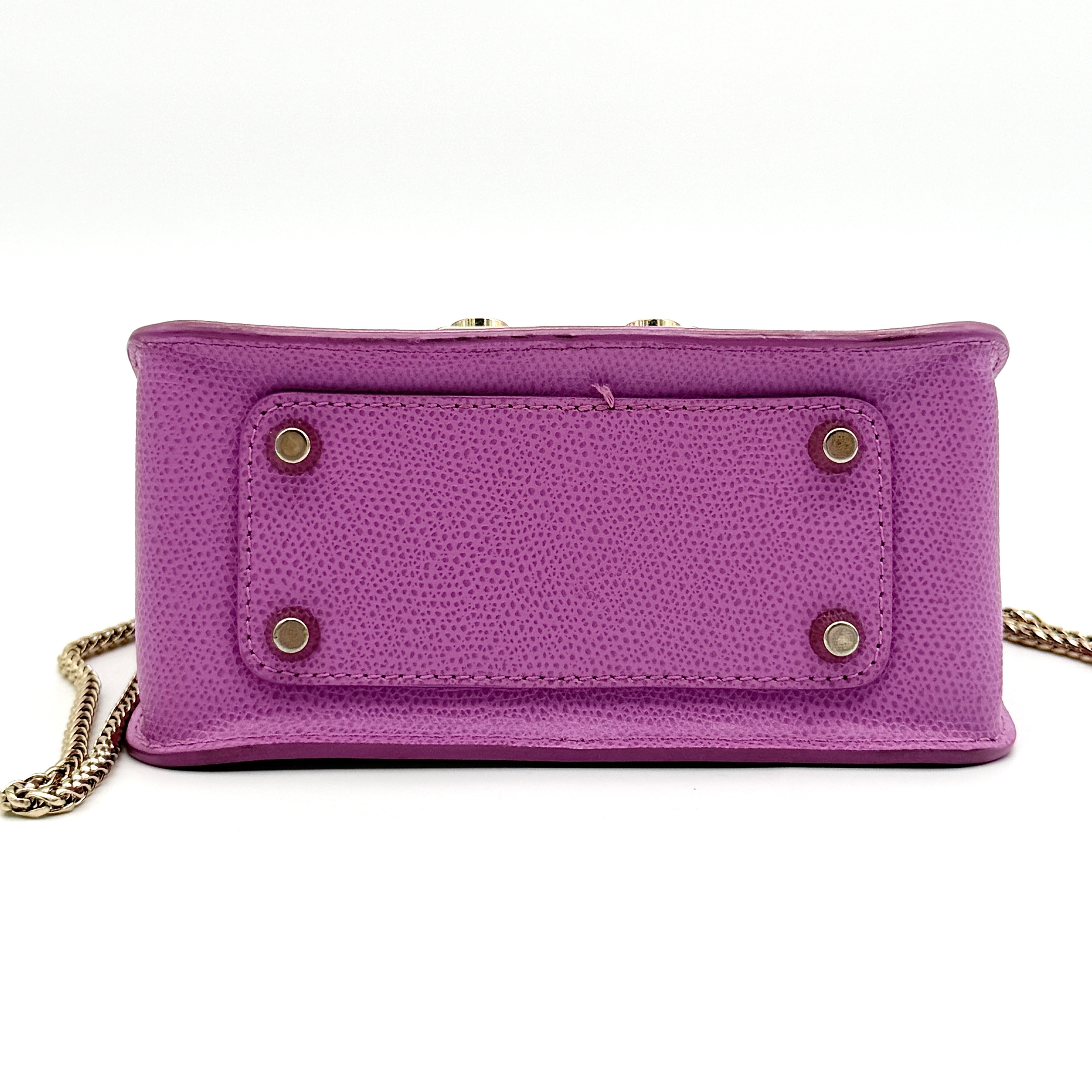 Furla Metropolis crossbody bag in pink grained leather with gold hardware and chain strap, displayed against a white background.