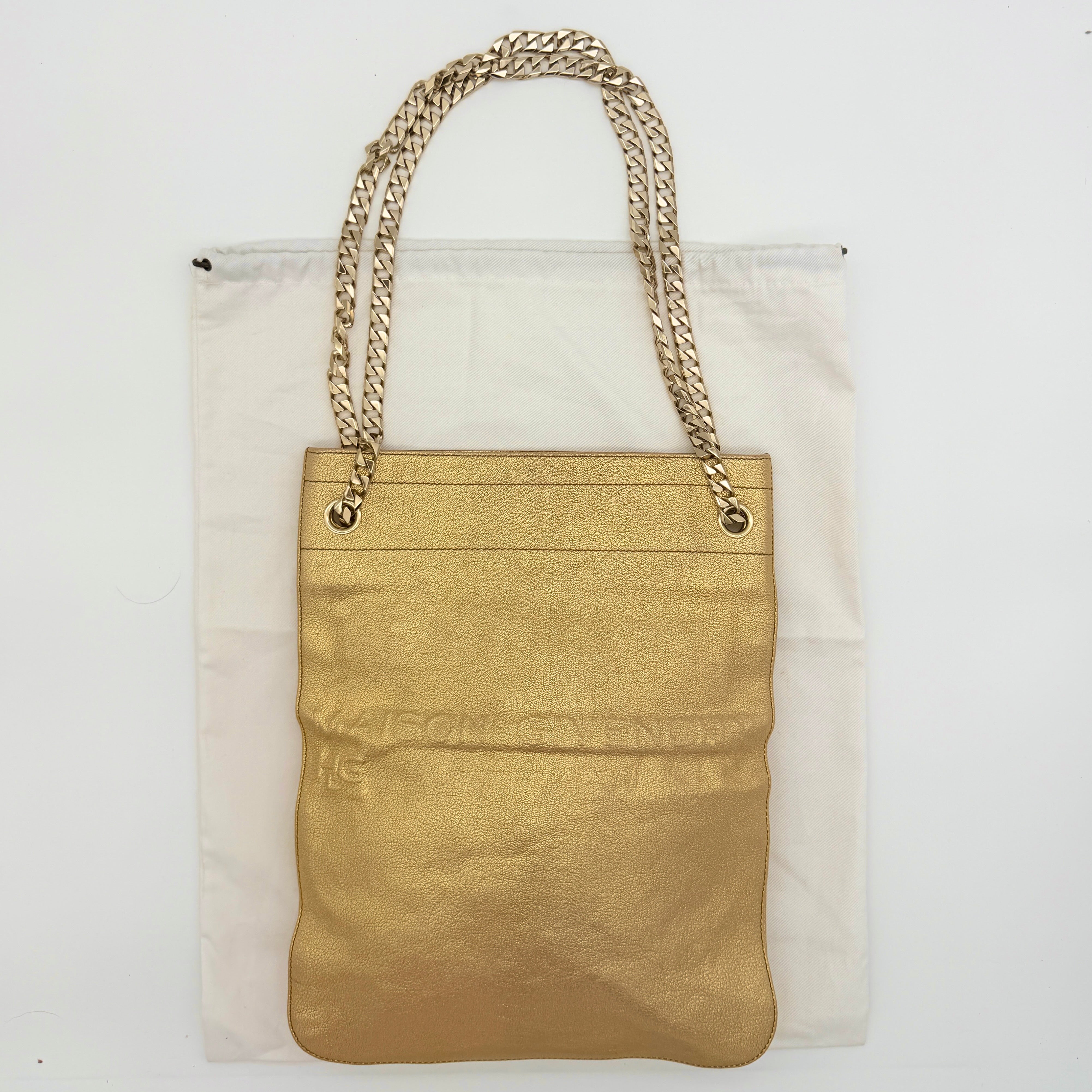 Givenchy metallic gold chain shoulder bag with gold-tone chain straps and embossed logo, displayed on a dust bag.