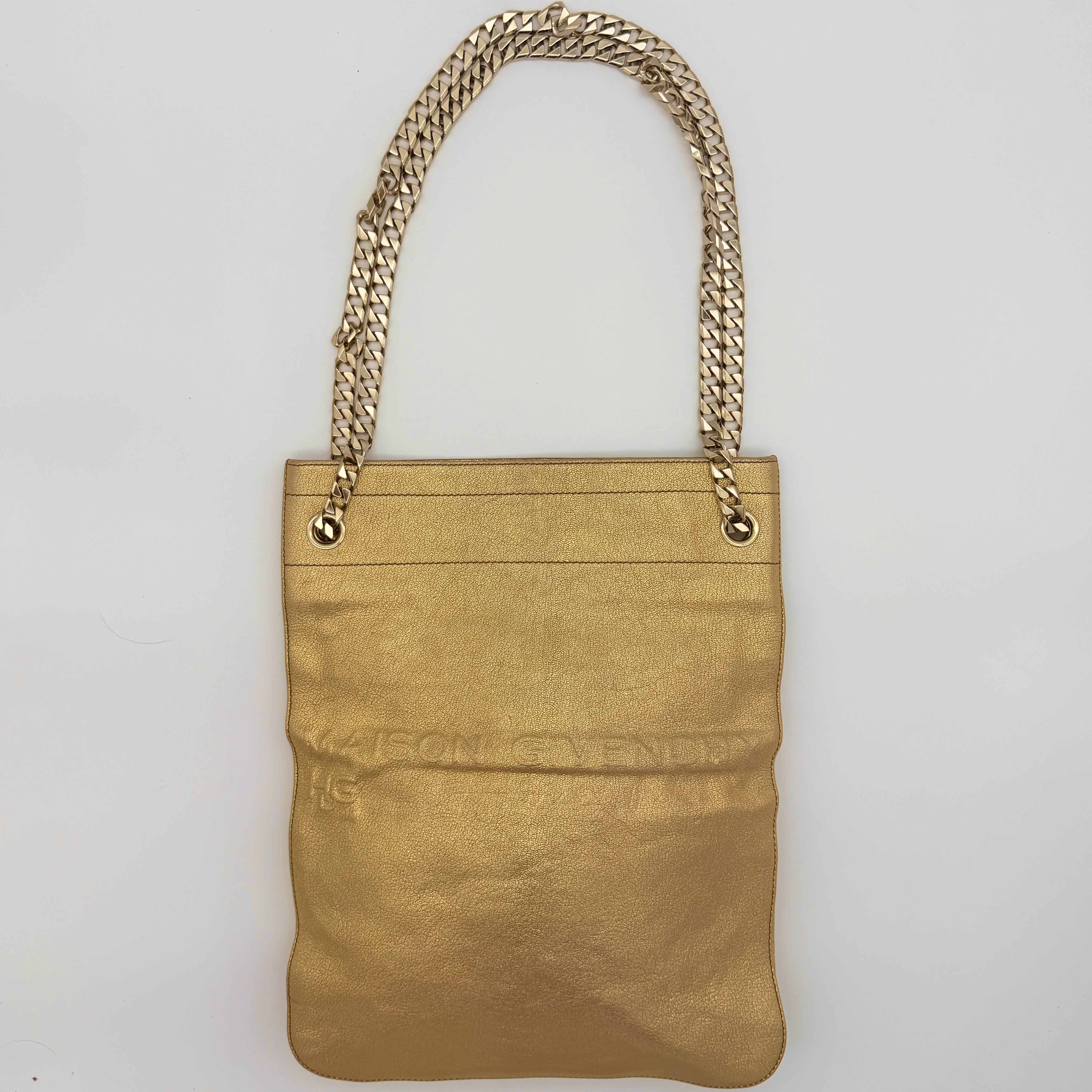 Givenchy metallic gold chain shoulder bag with gold-tone chain straps and embossed logo, displayed on a dust bag.