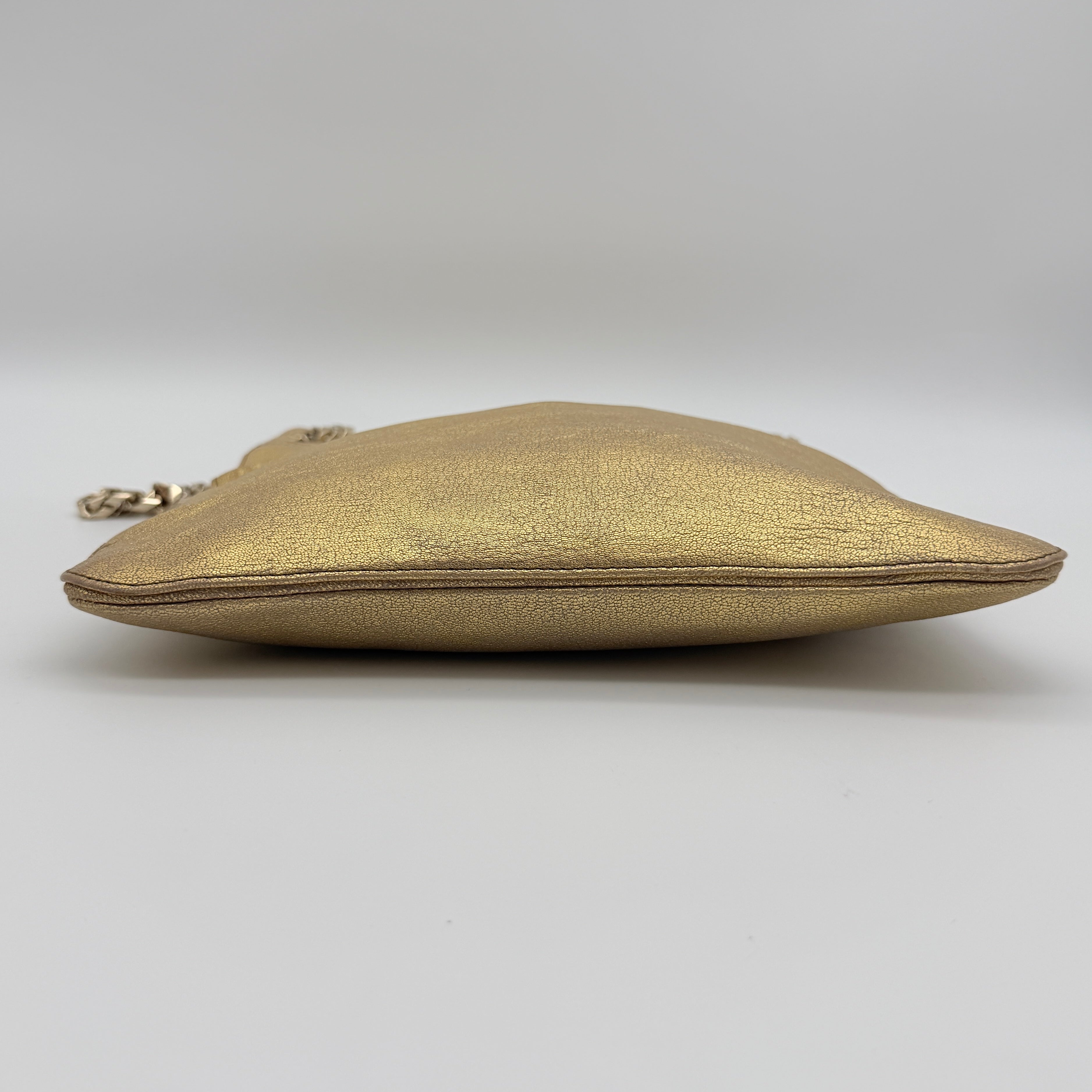 Givenchy metallic gold chain shoulder bag with gold-tone chain straps and embossed logo, displayed on a dust bag.