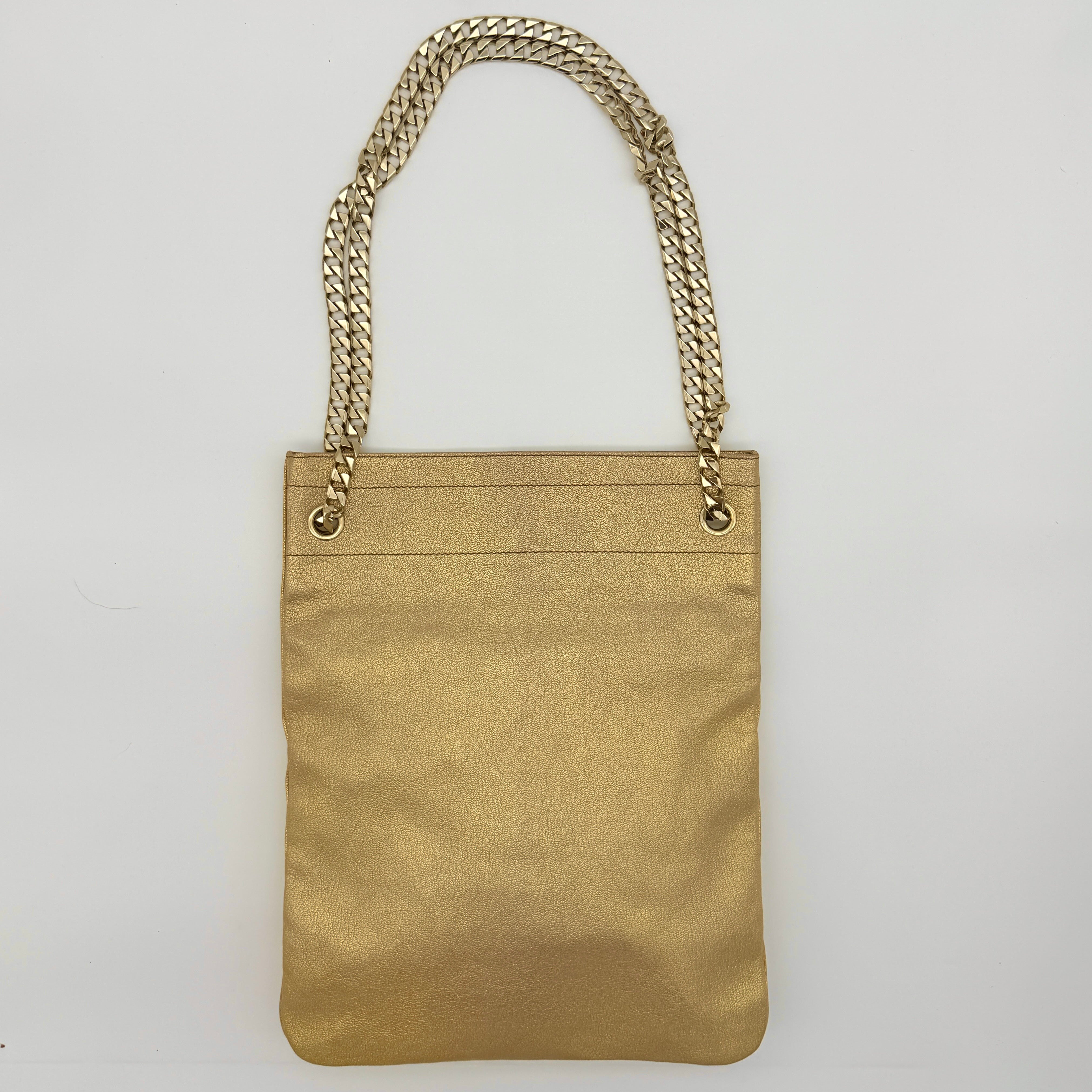 Givenchy metallic gold chain shoulder bag with gold-tone chain straps and embossed logo, displayed on a dust bag.