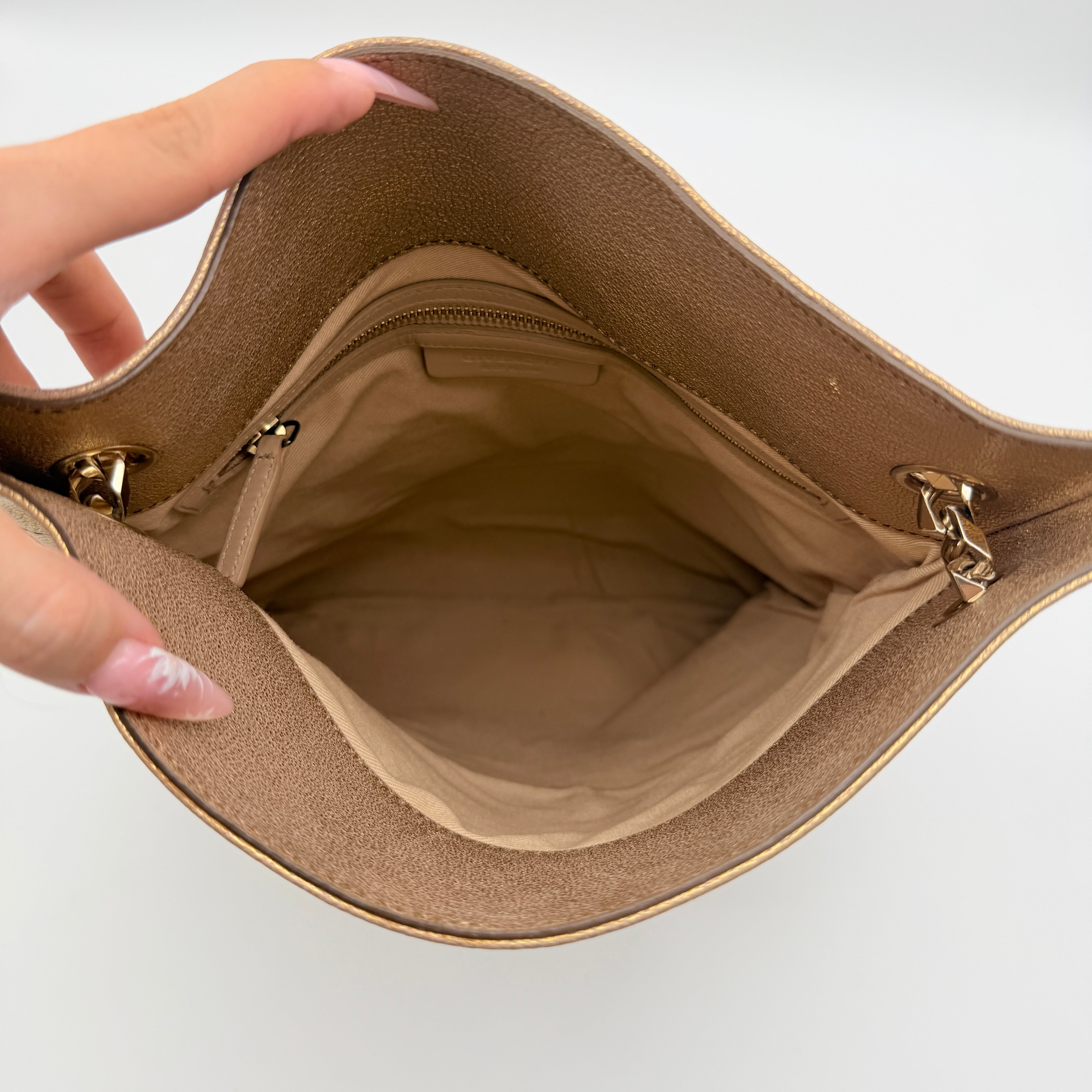 Givenchy metallic gold chain shoulder bag with gold-tone chain straps and embossed logo, displayed on a dust bag.