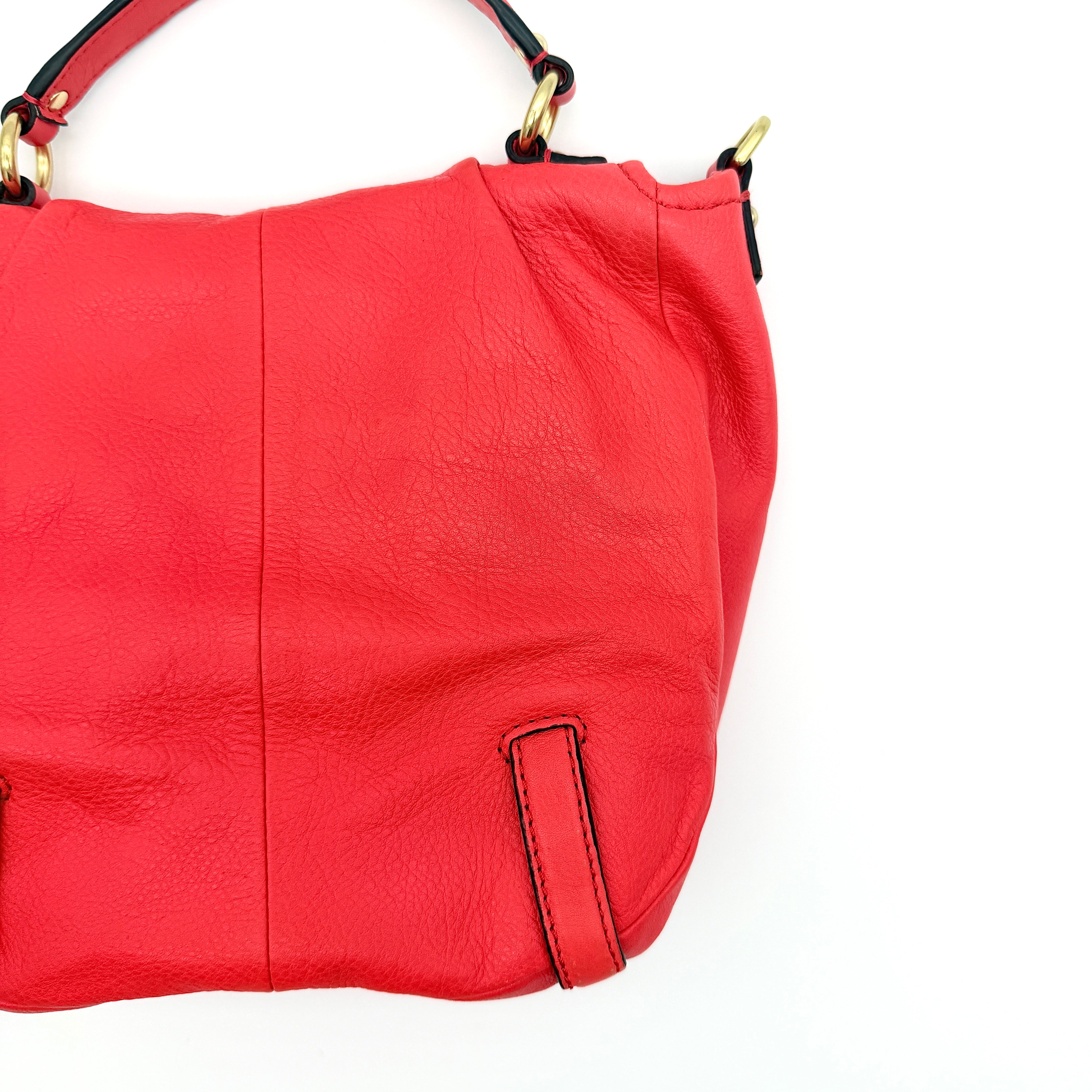 Coach Madison Anabelle red leather handbag with gold tone hardware, top handle, and detachable strap displayed on a white background