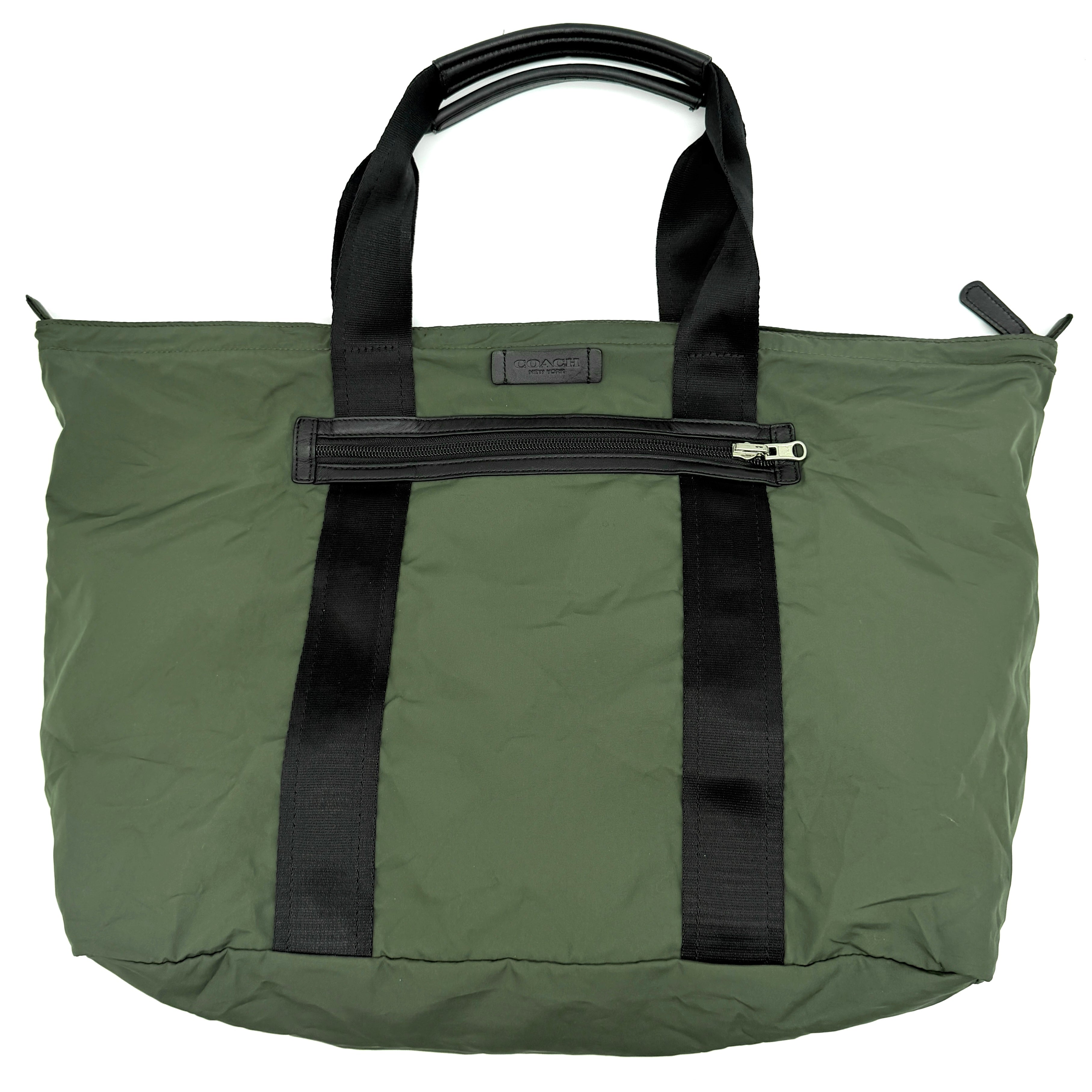 Coach Varick Packable Weekend Tote in green nylon with black web straps and a zippered external pocket.