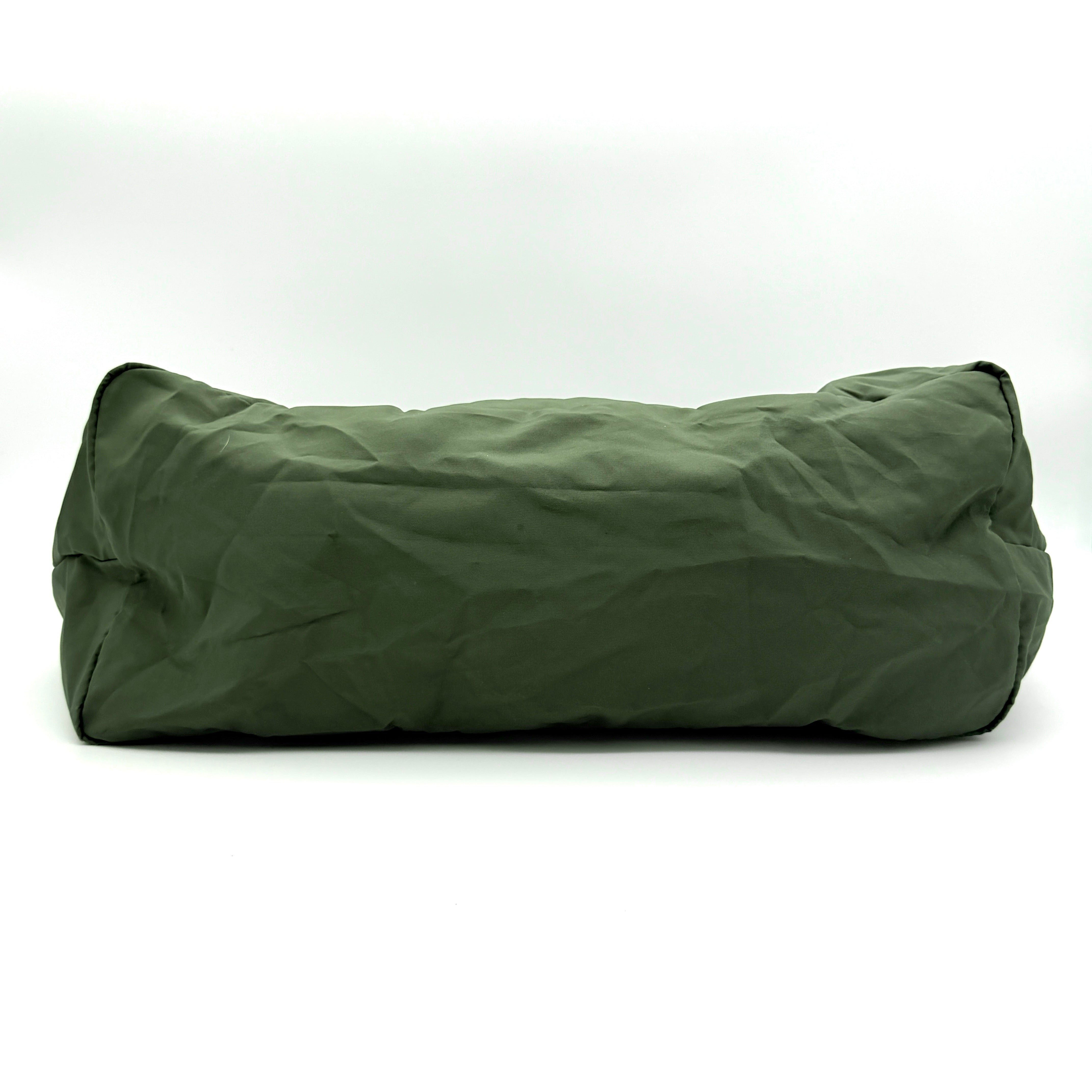 Coach Varick Packable Weekend Tote in green nylon with black web straps and a zippered external pocket.