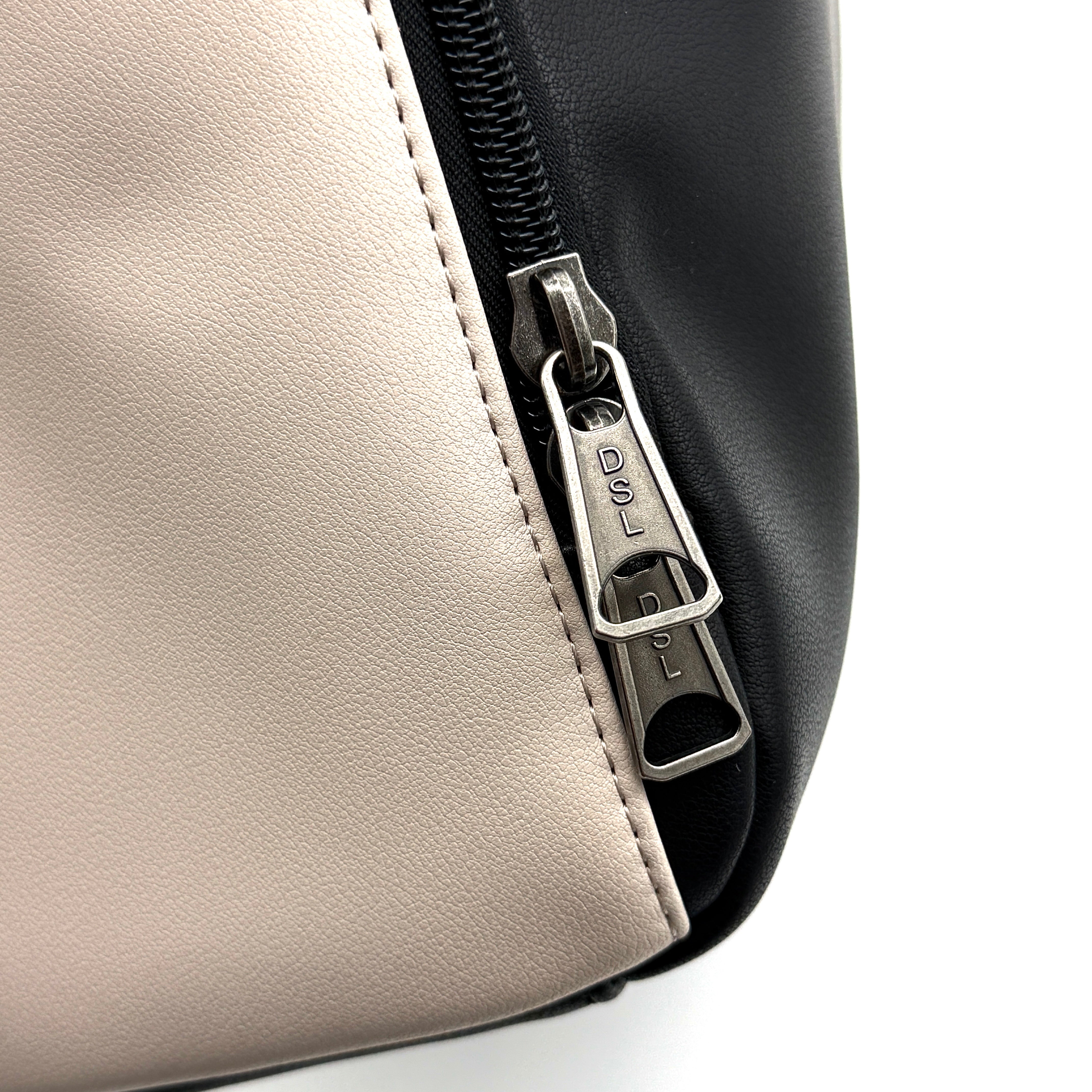 Diesel D-Logo Colorblock Backpack in black and white faux leather with a red logo patch and silver-tone hardware.