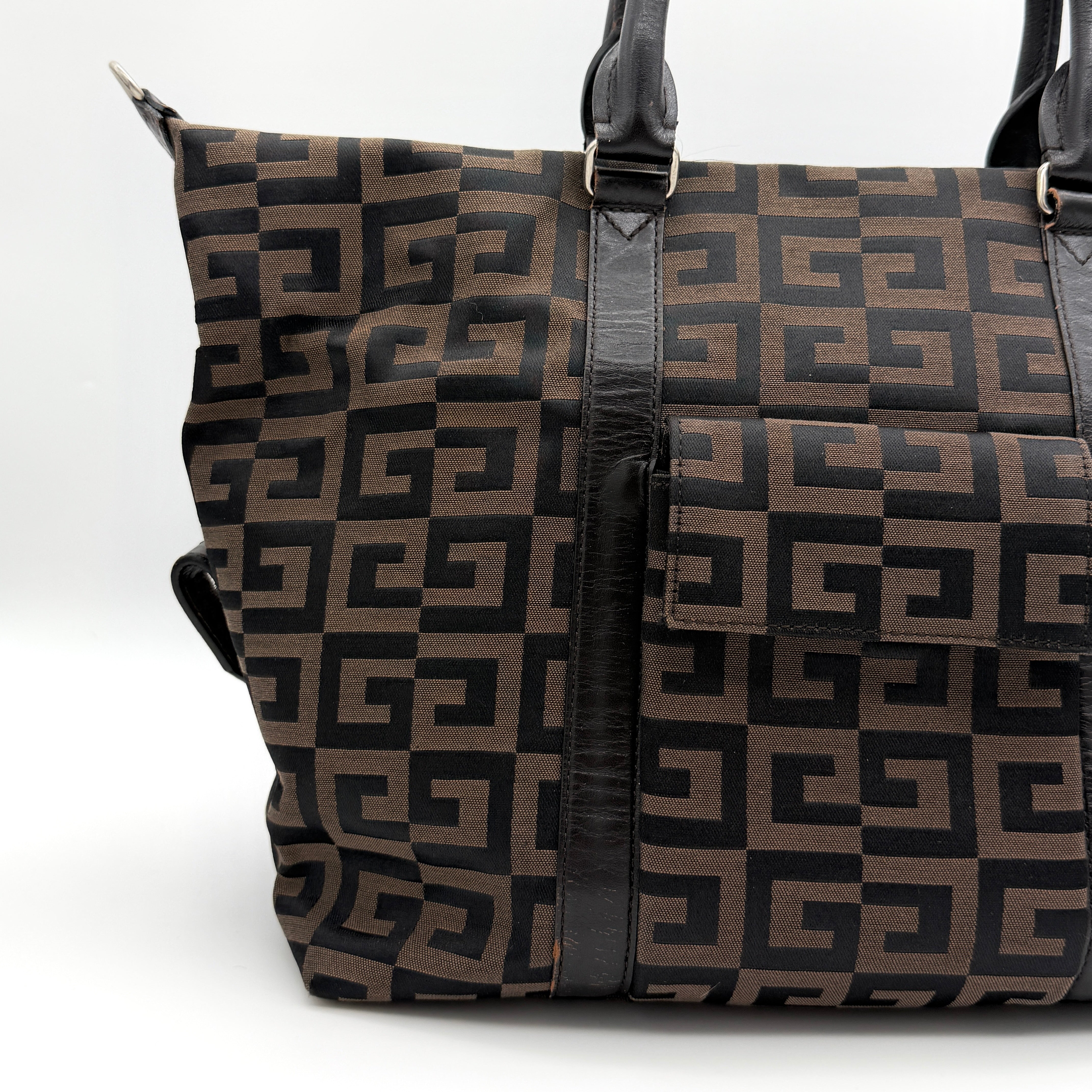 Givenchy 4G Monogram Handbag in brown and black fabric with leather handles and bold graphic pattern.