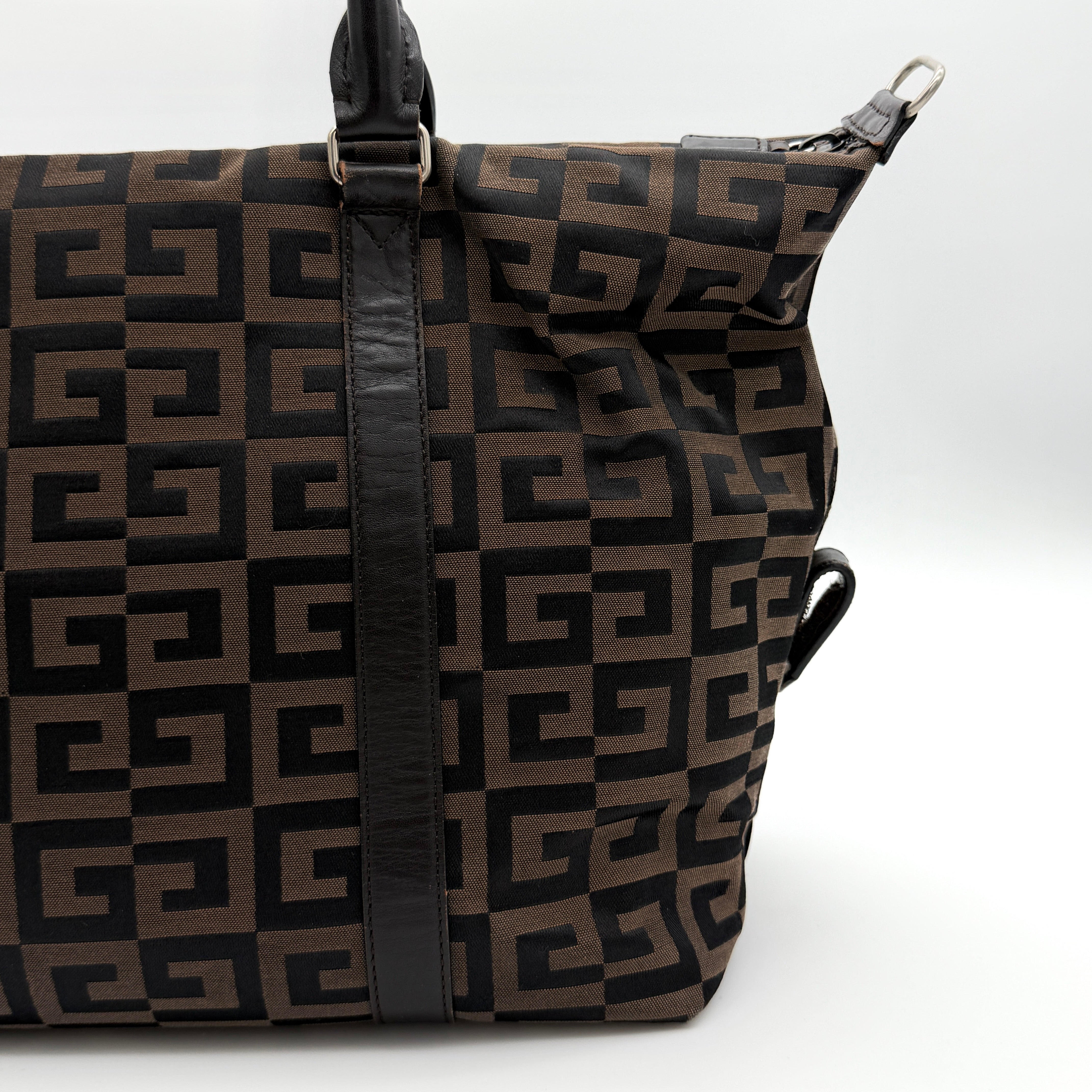 Givenchy 4G Monogram Handbag in brown and black fabric with leather handles and bold graphic pattern.