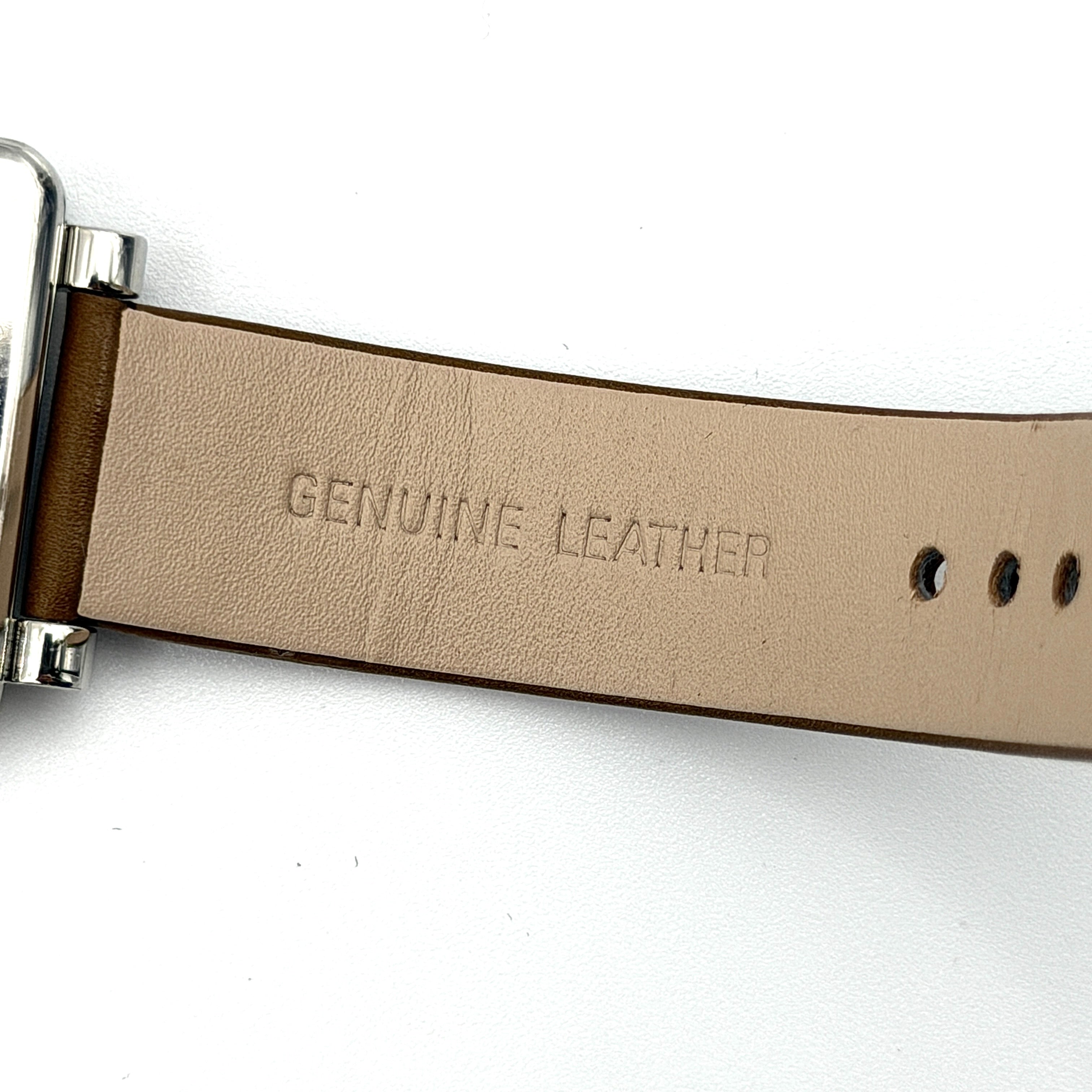 Marc Jacobs MJ1436 silver square watch with brown leather strap displayed on a branded watch cushion.