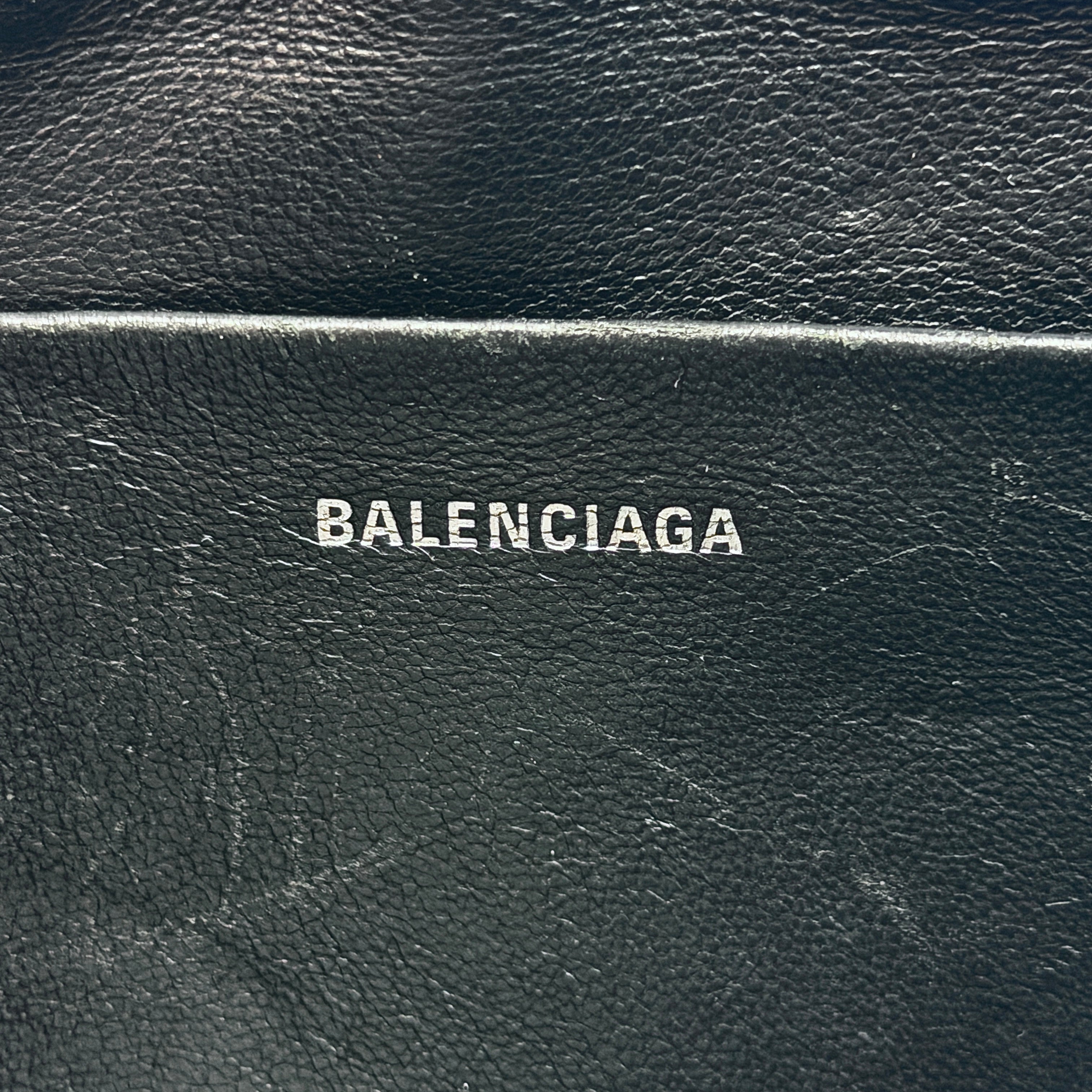 Balenciaga Signature BB Monogram Everyday Clutch Bag in black with double zip compartments and detachable wrist strap displayed on a Balenciaga dust bag.