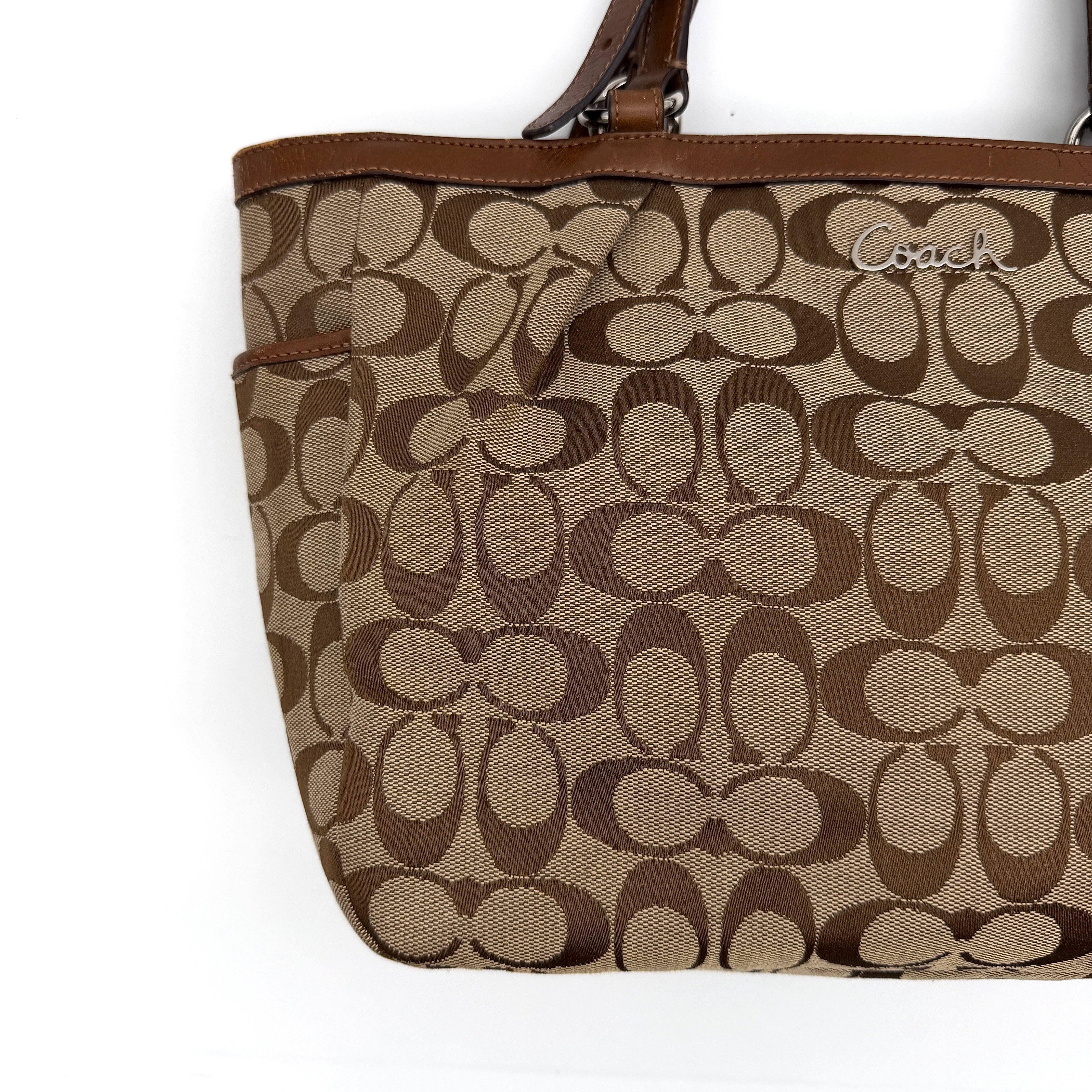 Coach Signature Gallery Tote Bag in beige and brown with double leather handles and the iconic logo pattern.